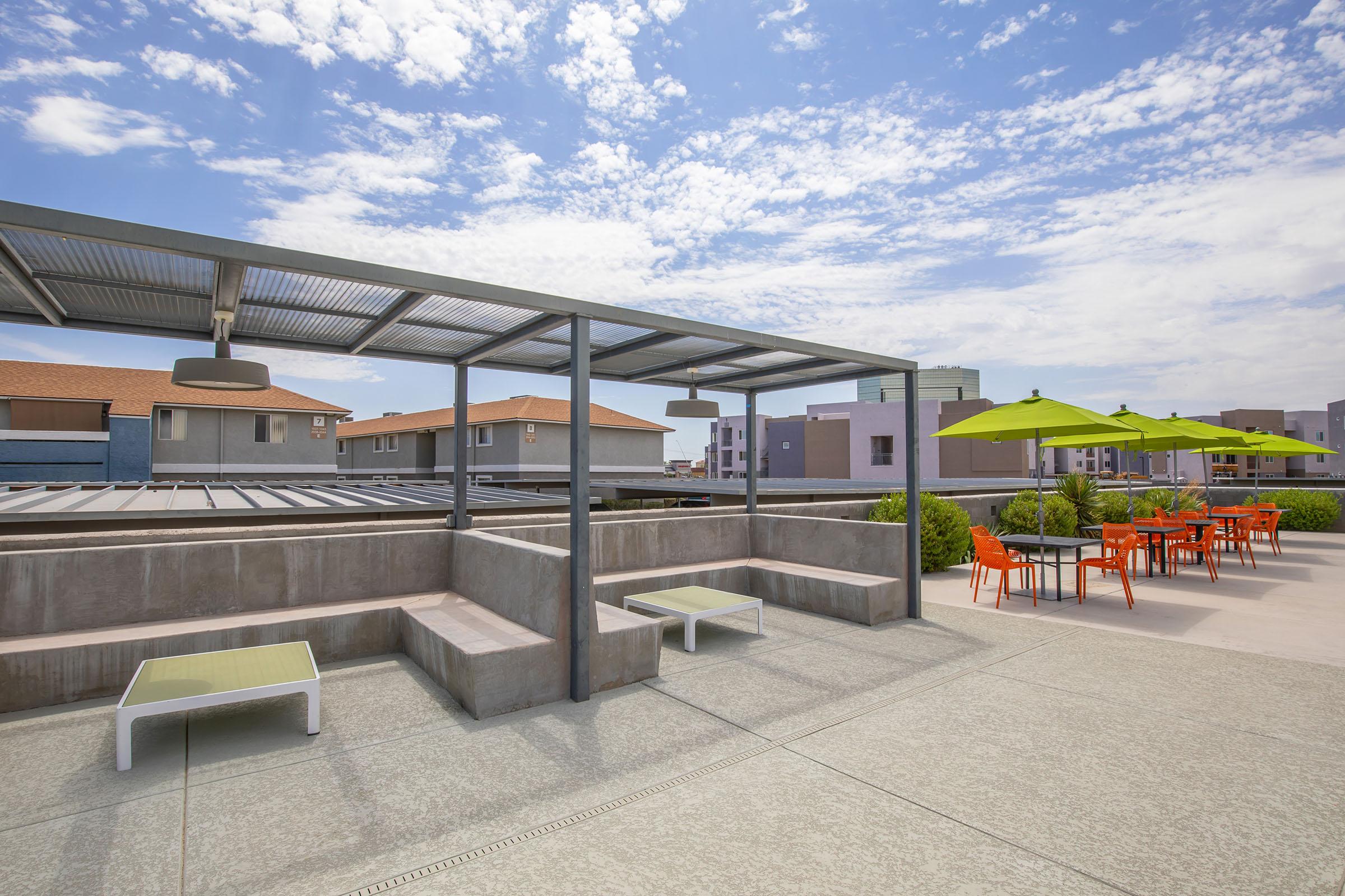 Rise at the District apartments outdoor patio with cabanas, tables, and chairs