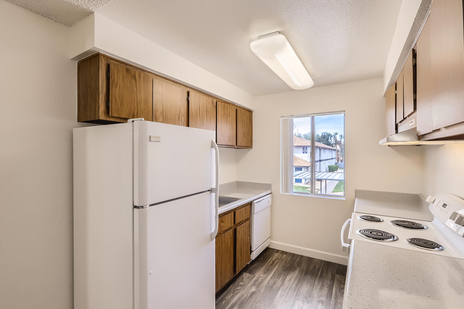 a kitchen with a stove and a refrigerator