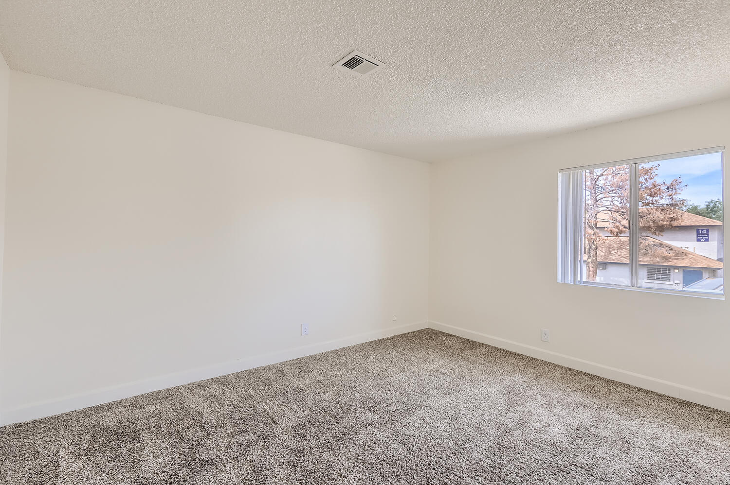 a bedroom with a large window