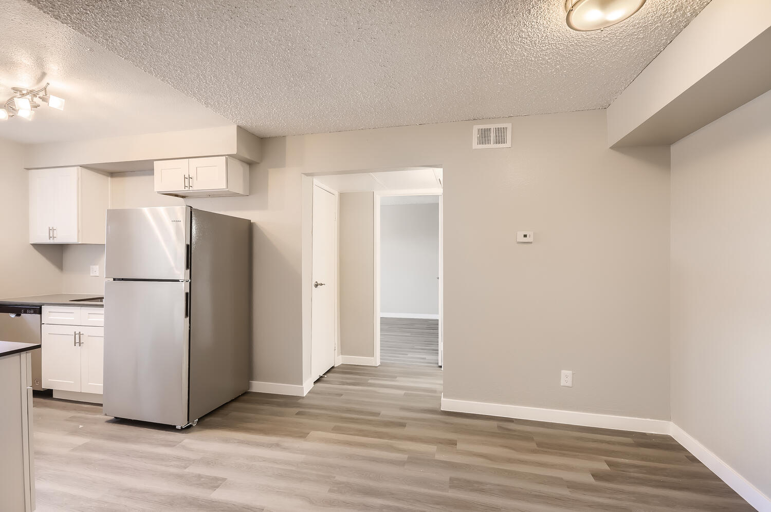 a kitchen with a sink and a refrigerator