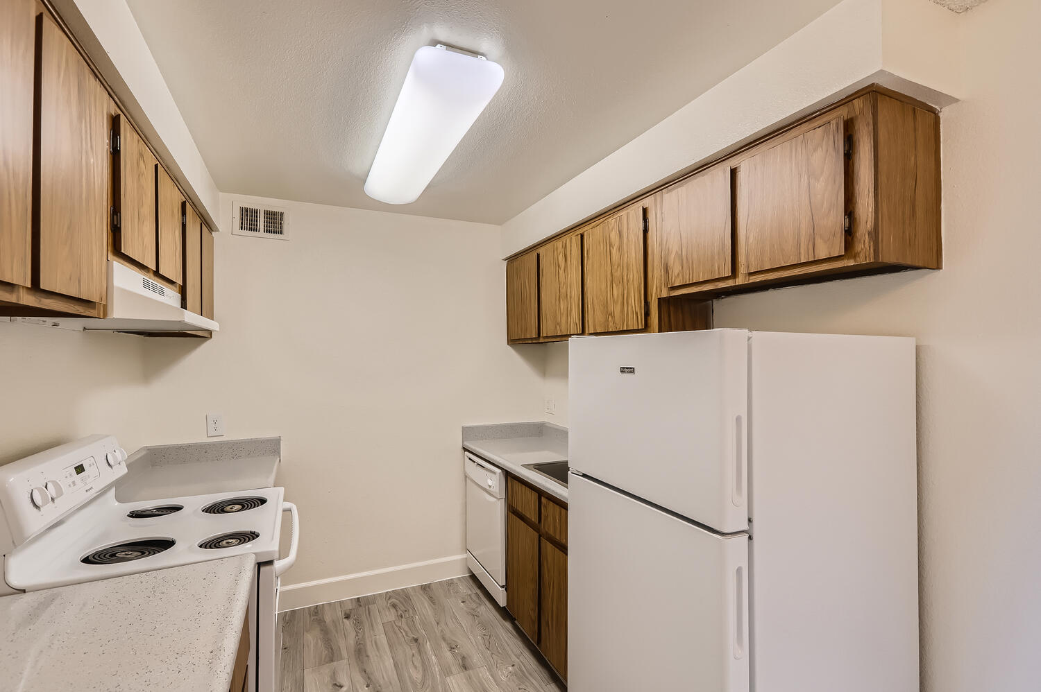 a kitchen with a stove and a refrigerator