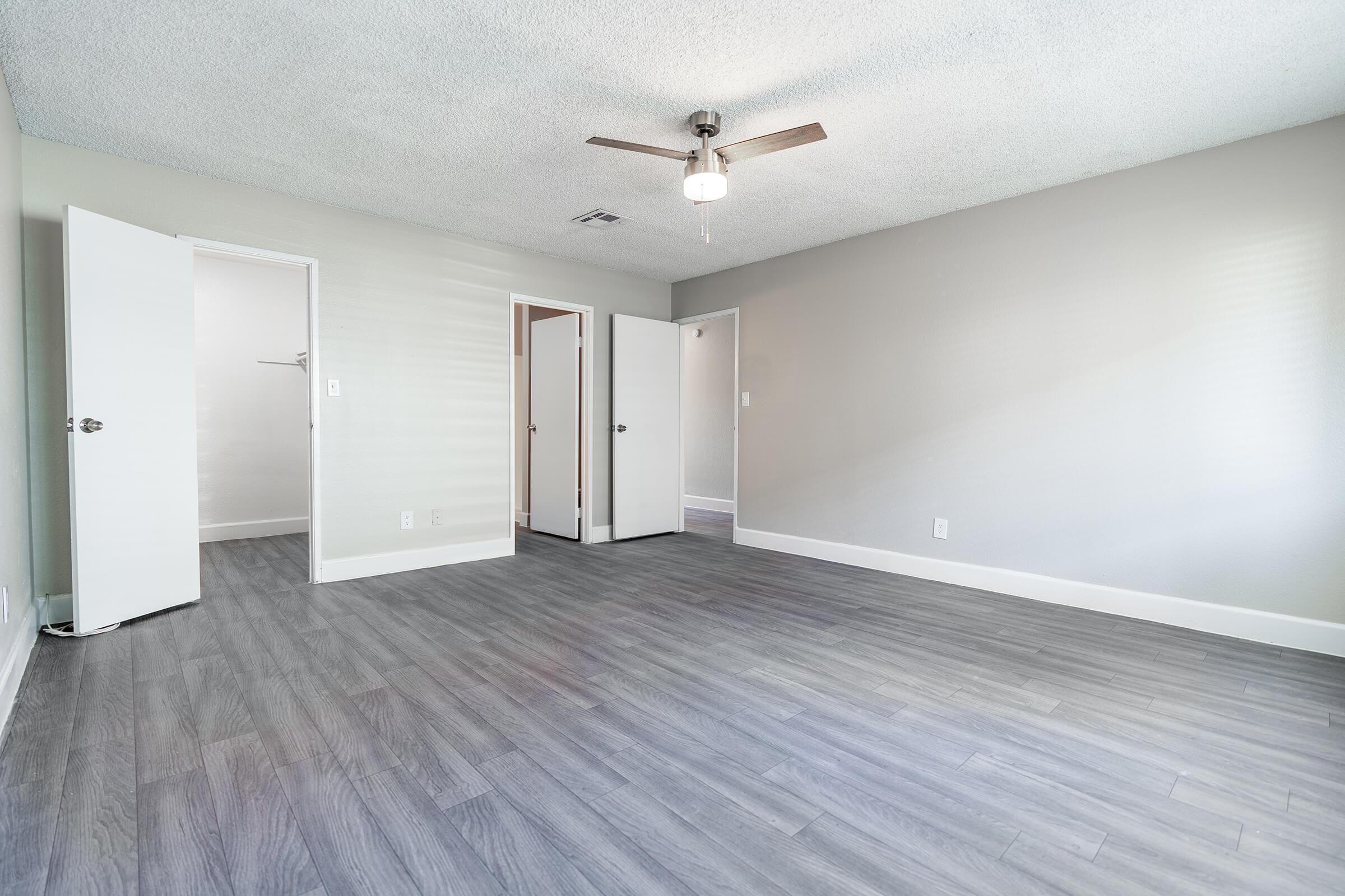 Large bedroom with grey wood flooring