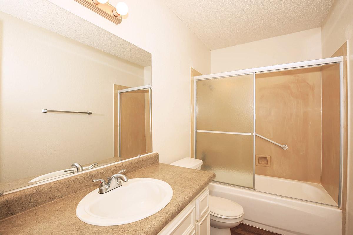 a hotel room with a sink and a mirror