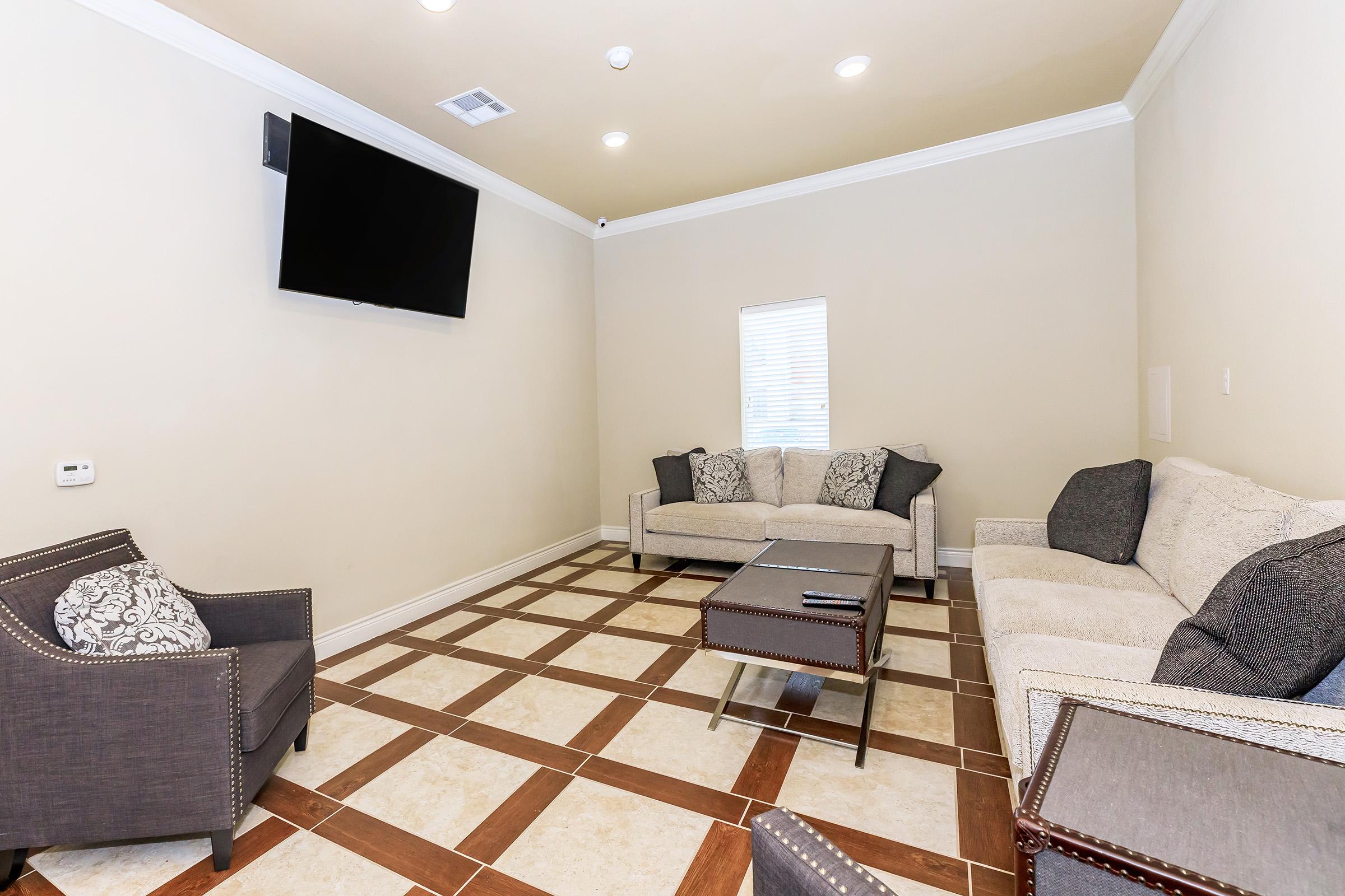 a living room filled with furniture and a rug