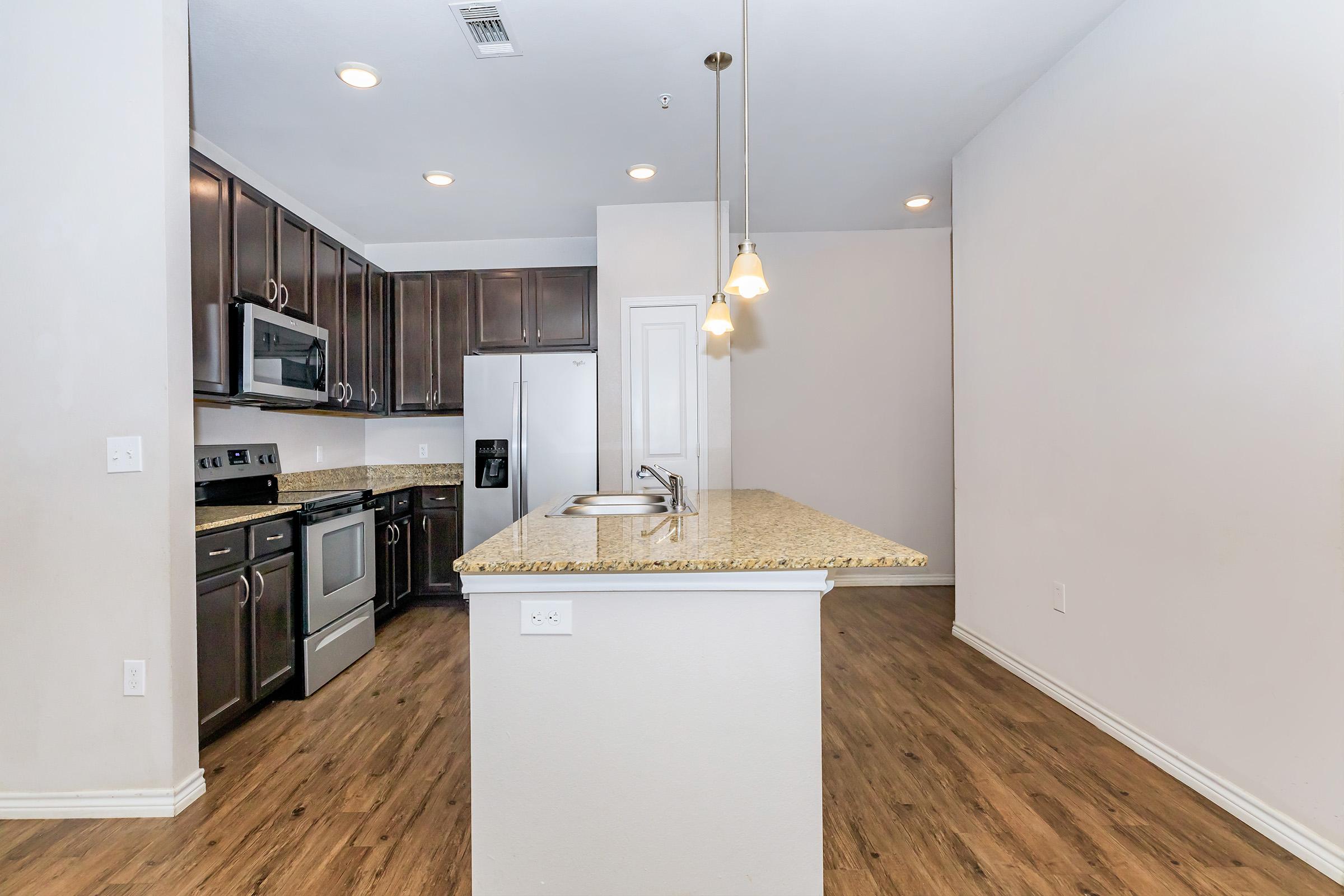 a kitchen with a sink and a refrigerator