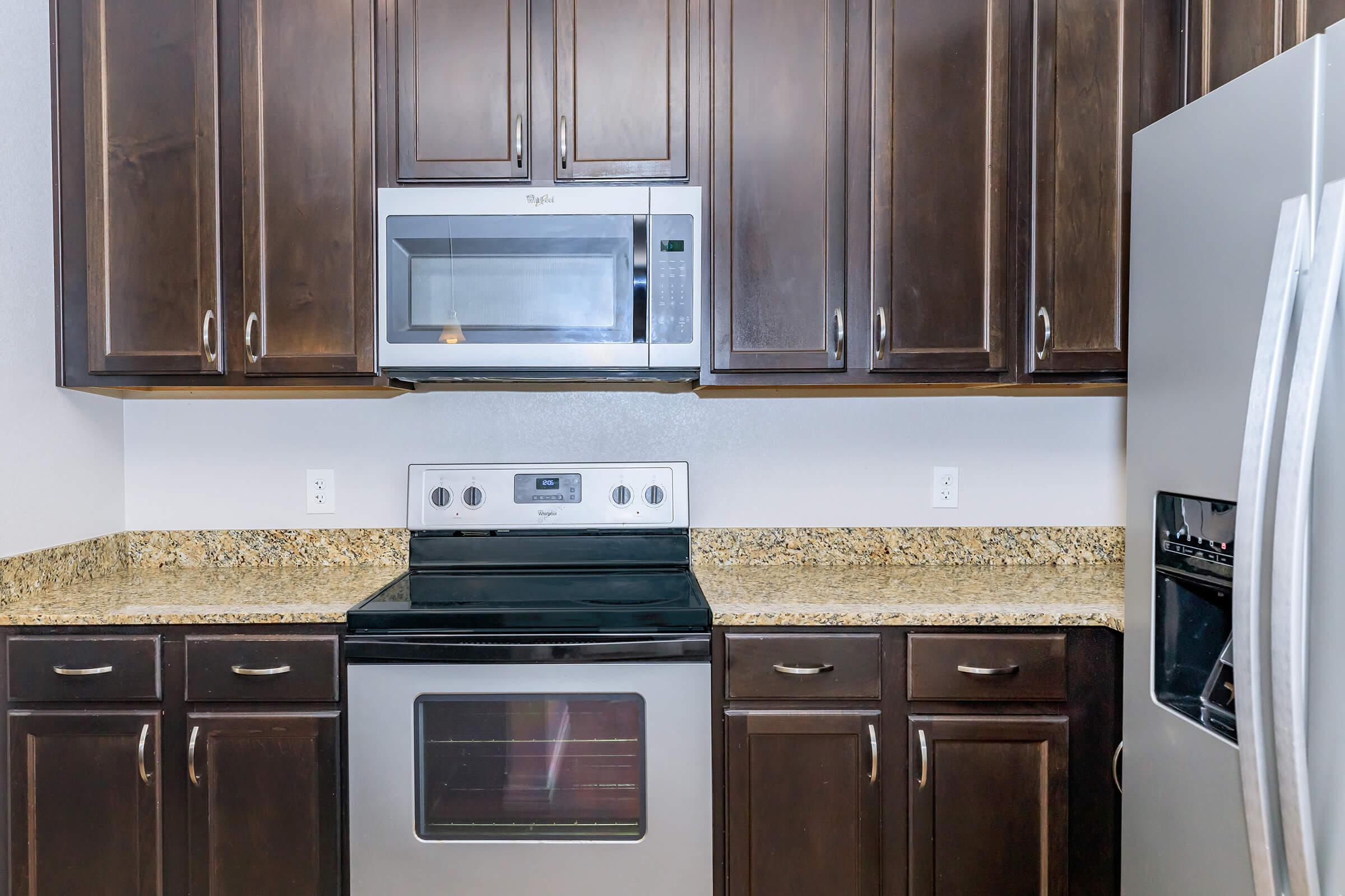 a kitchen with stainless steel appliances and wooden cabinets