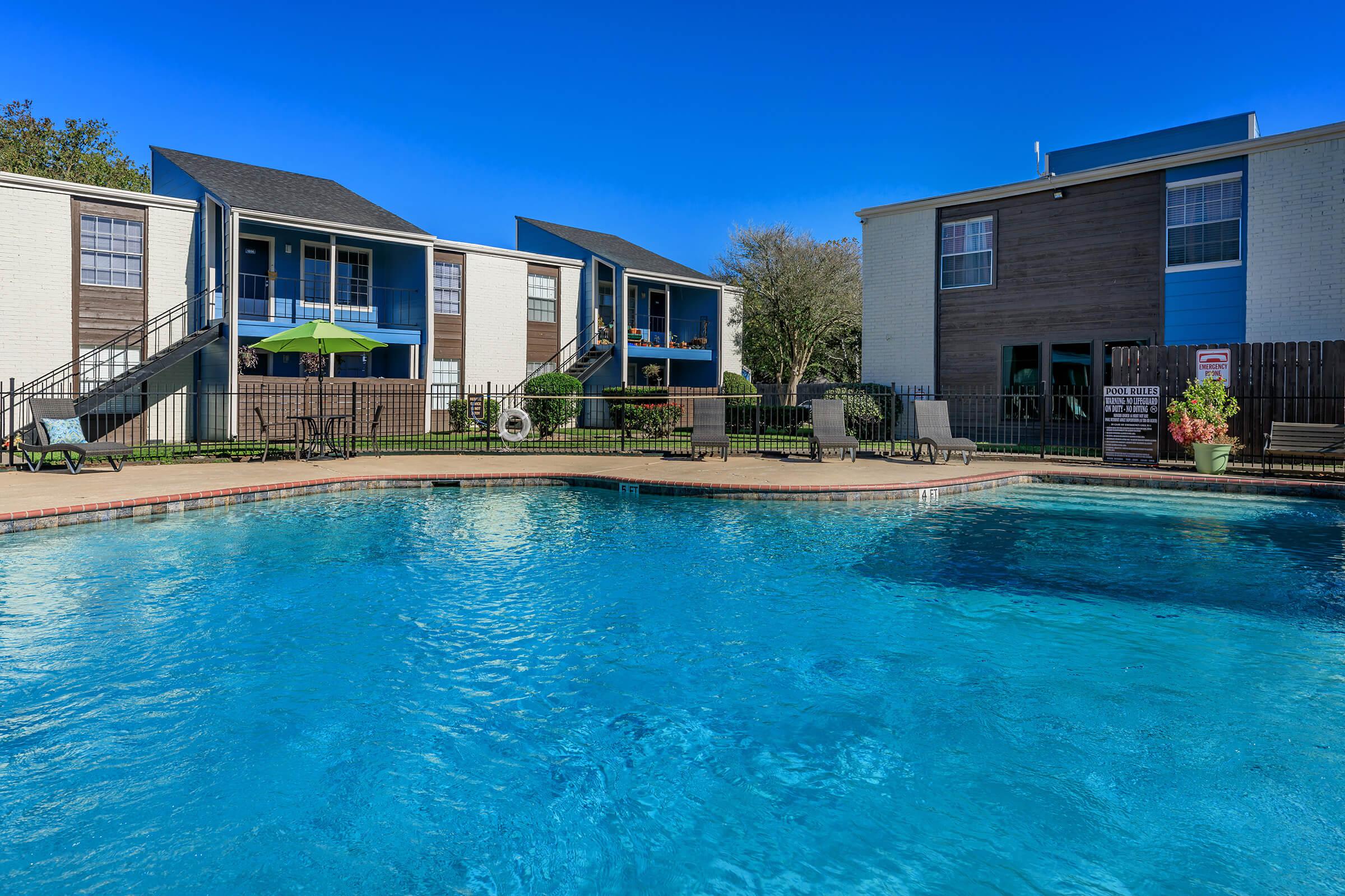 a large pool of water in front of a house