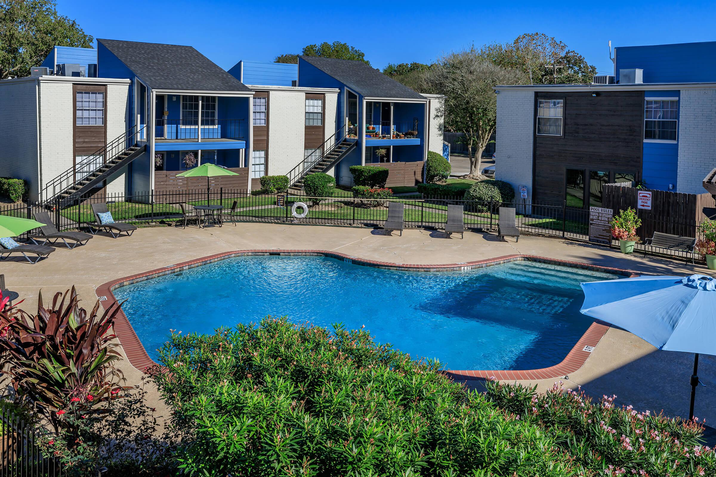 a house with a pool in front of a building