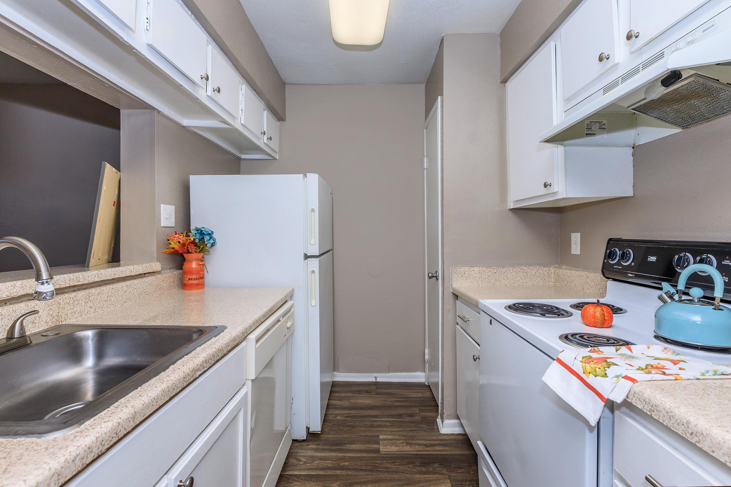 a kitchen with a stove and a sink