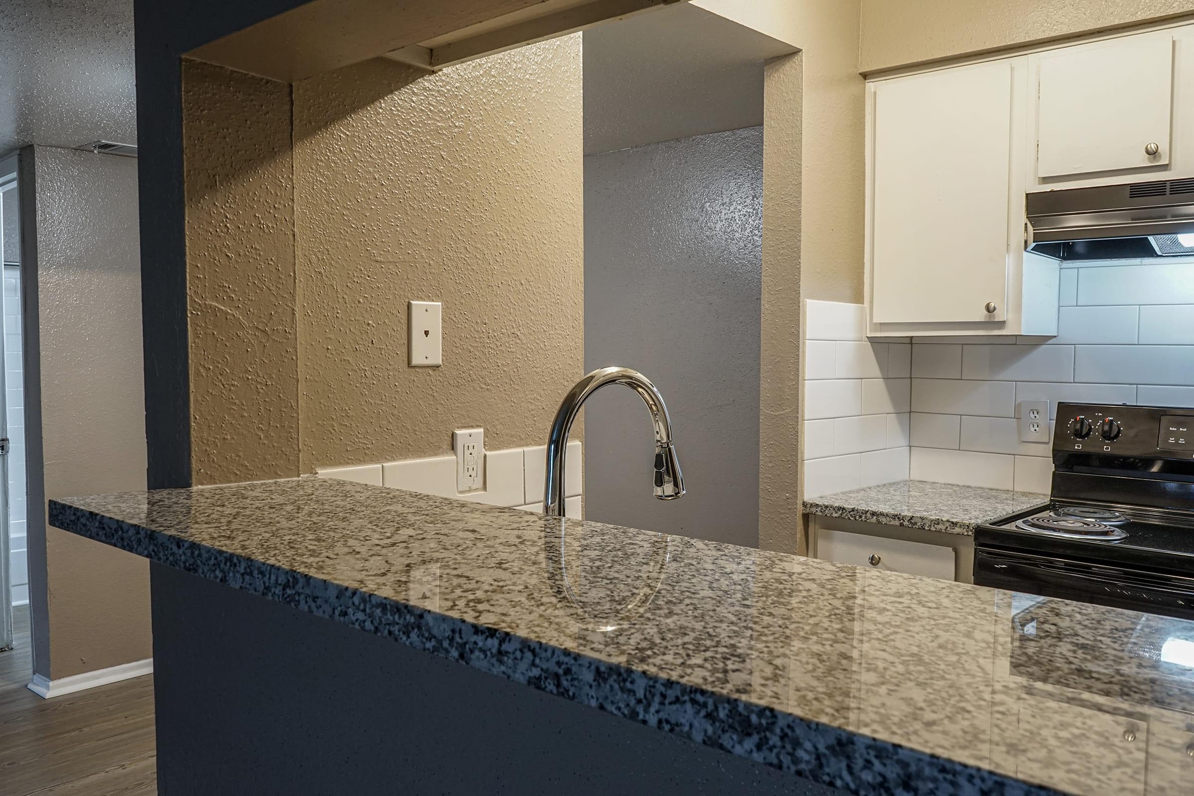 a kitchen with a sink and a mirror