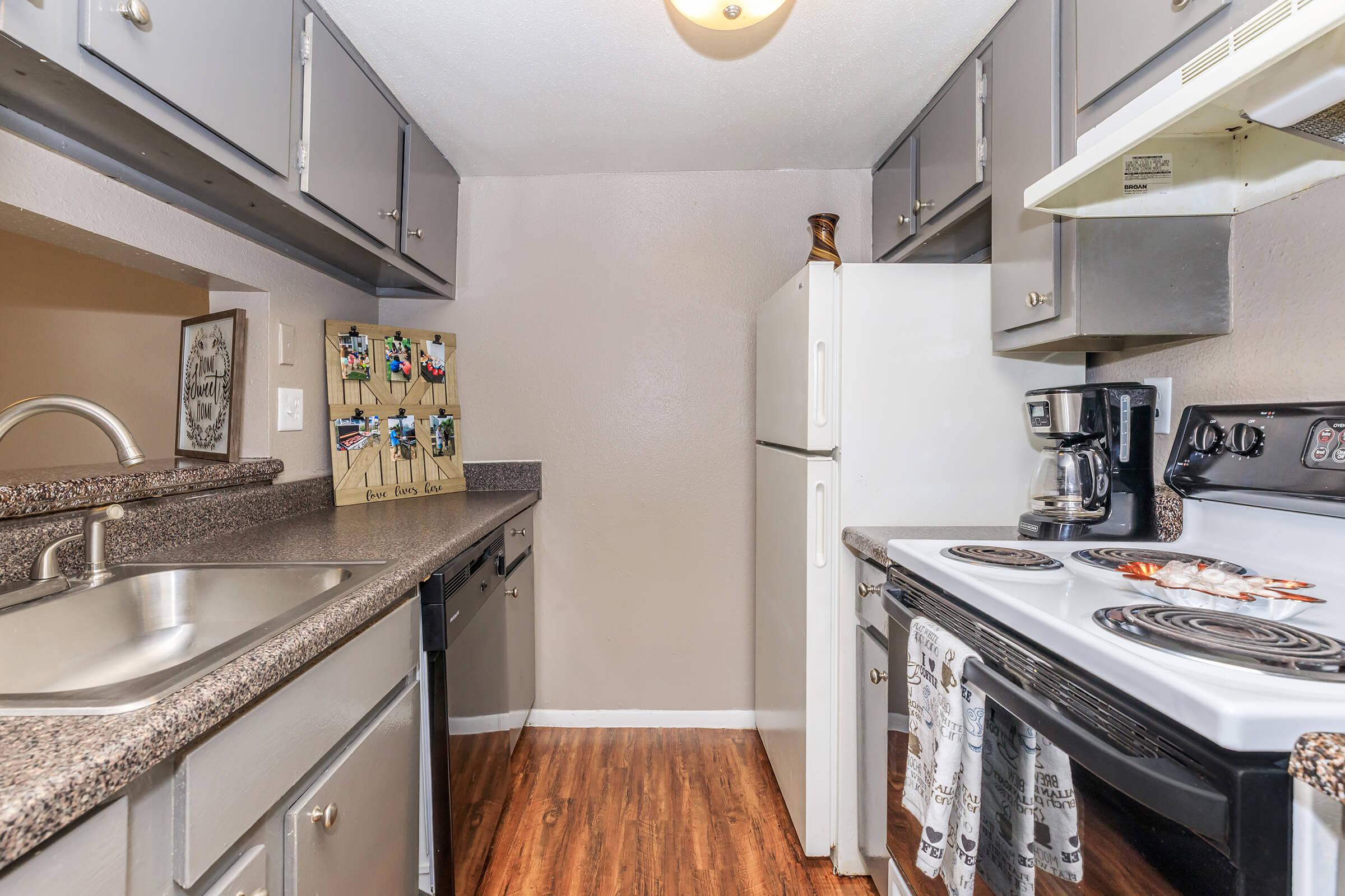 a kitchen with a stove sink and refrigerator