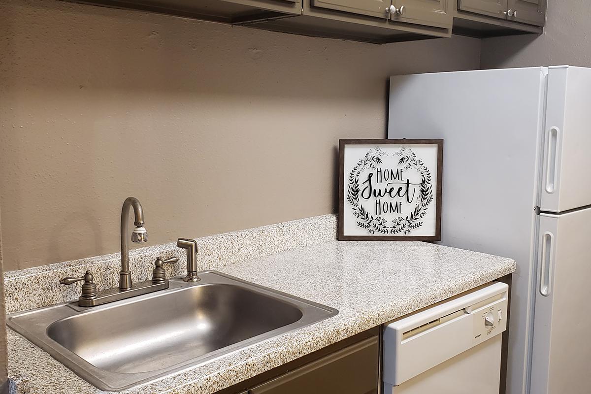 a kitchen with a sink and a mirror