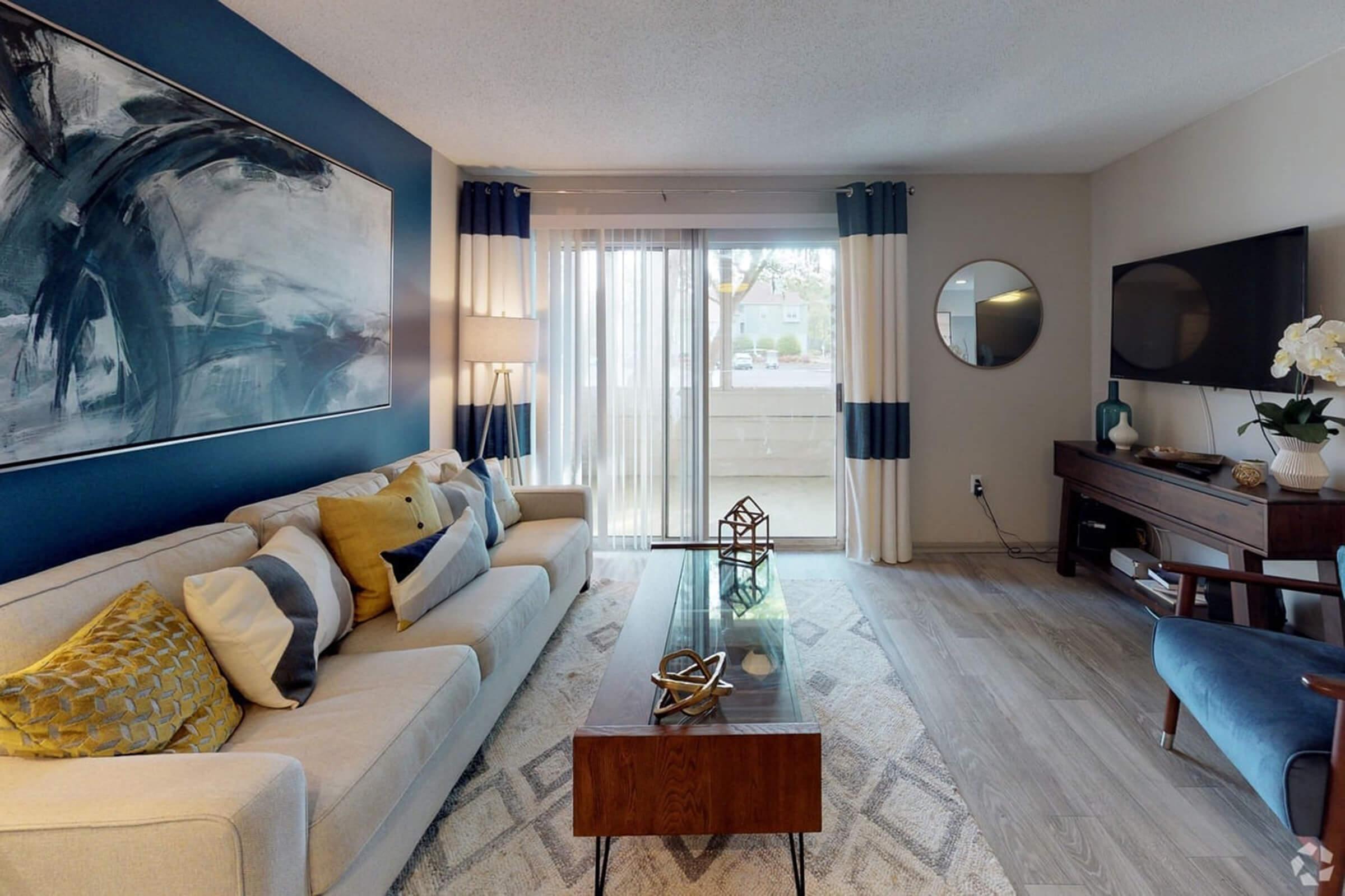 a living room filled with furniture and a large window