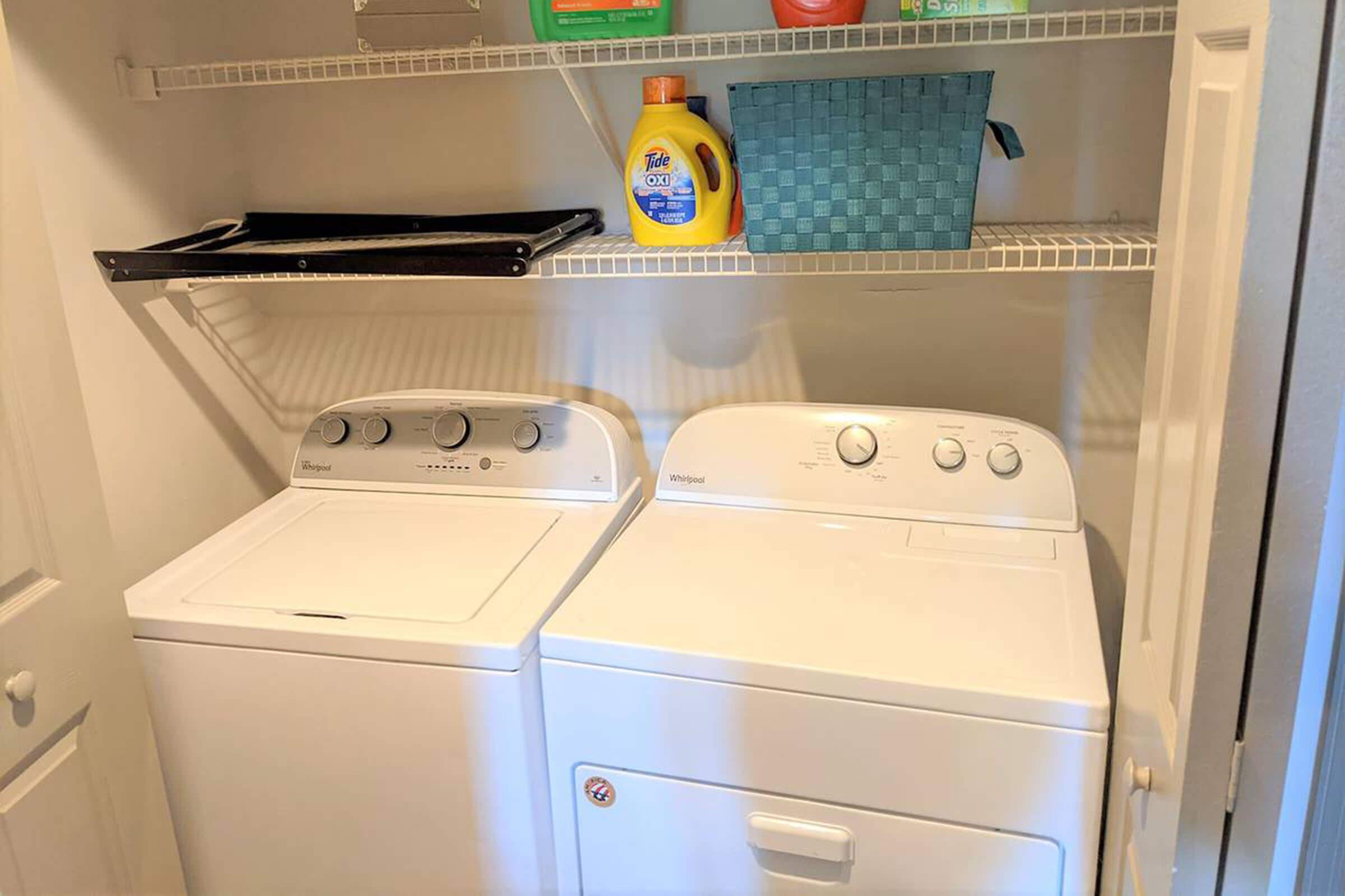 a microwave oven sitting on top of a refrigerator