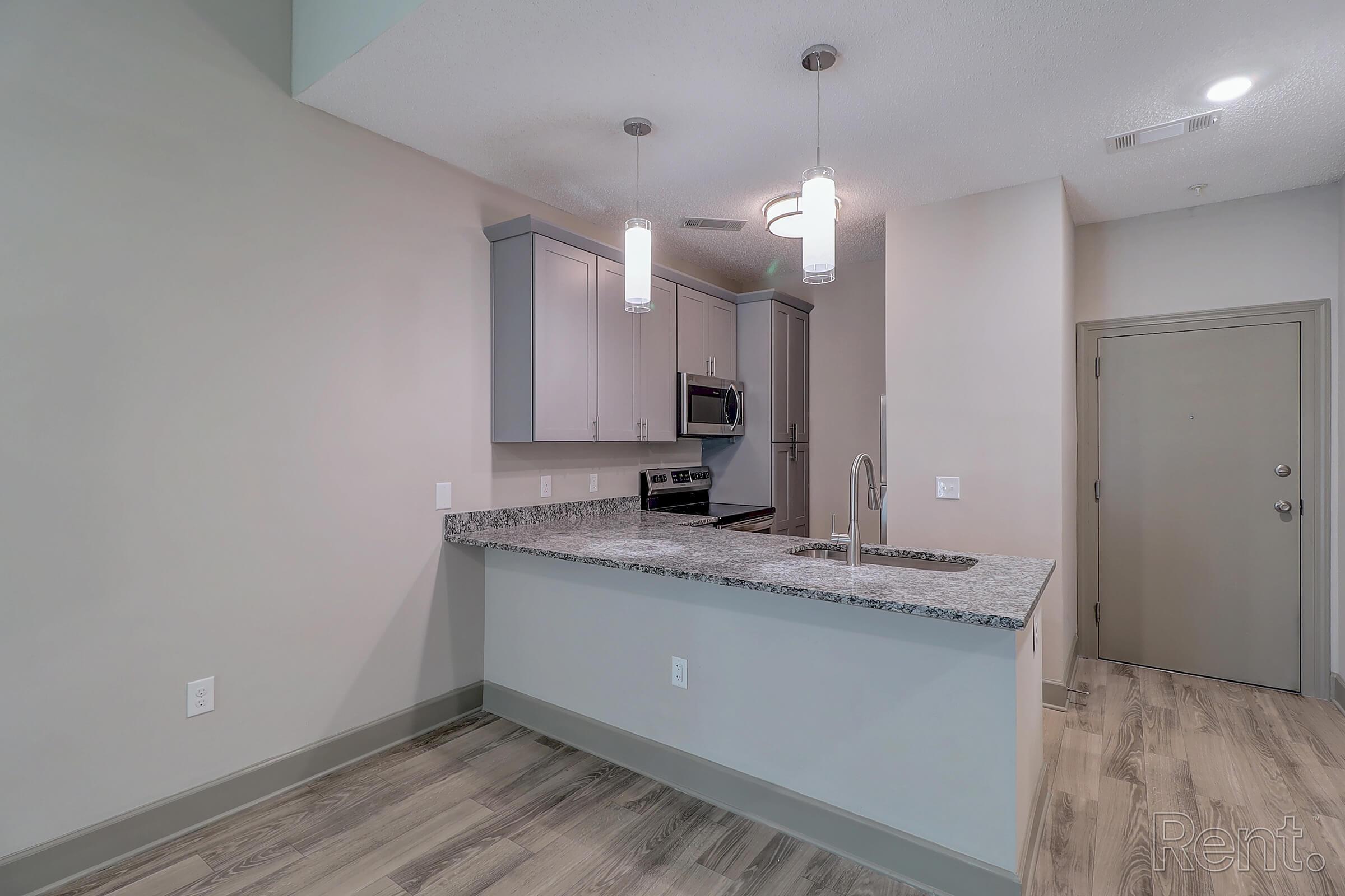 a kitchen with a sink and a mirror