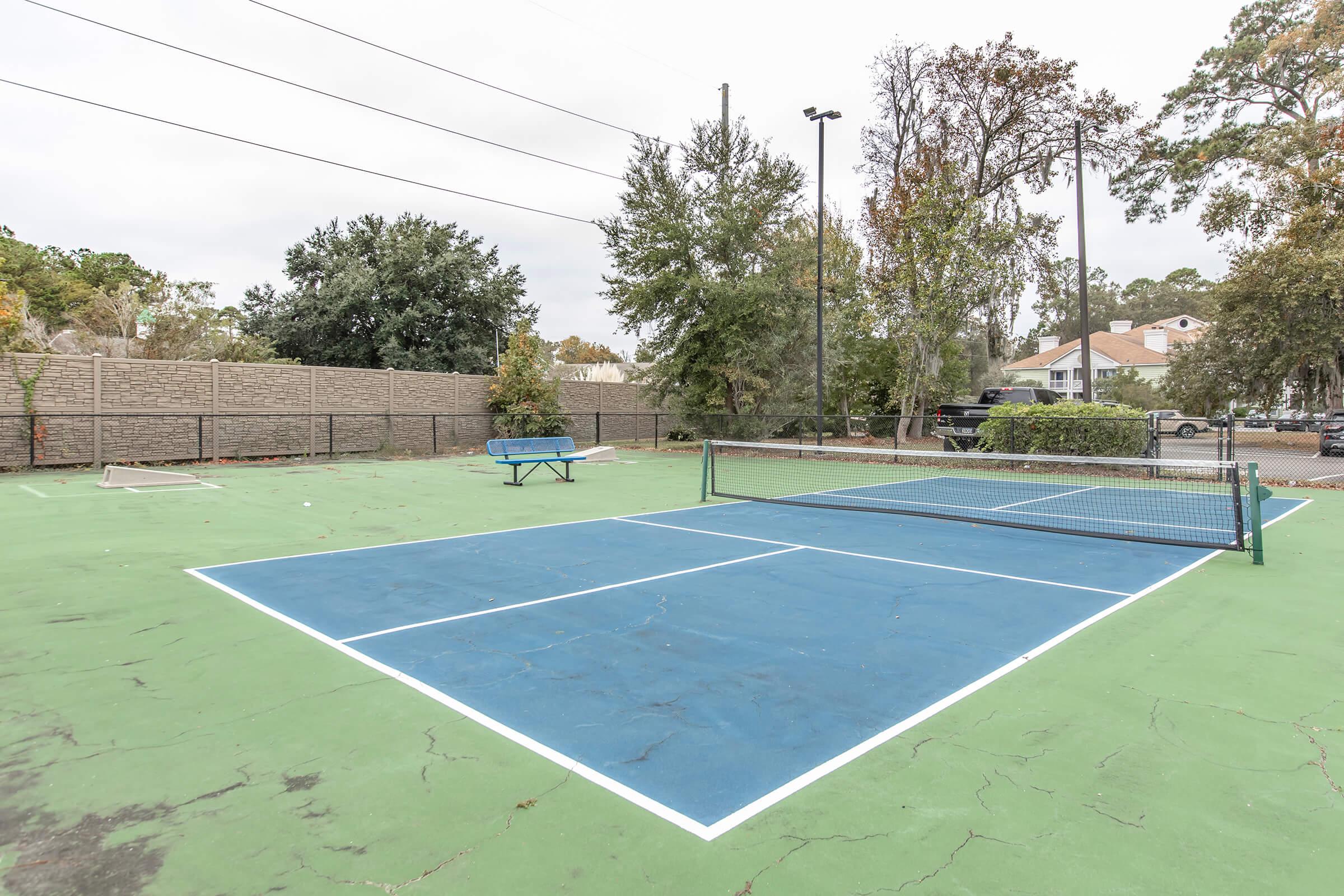 a group of people on a court with a racquet