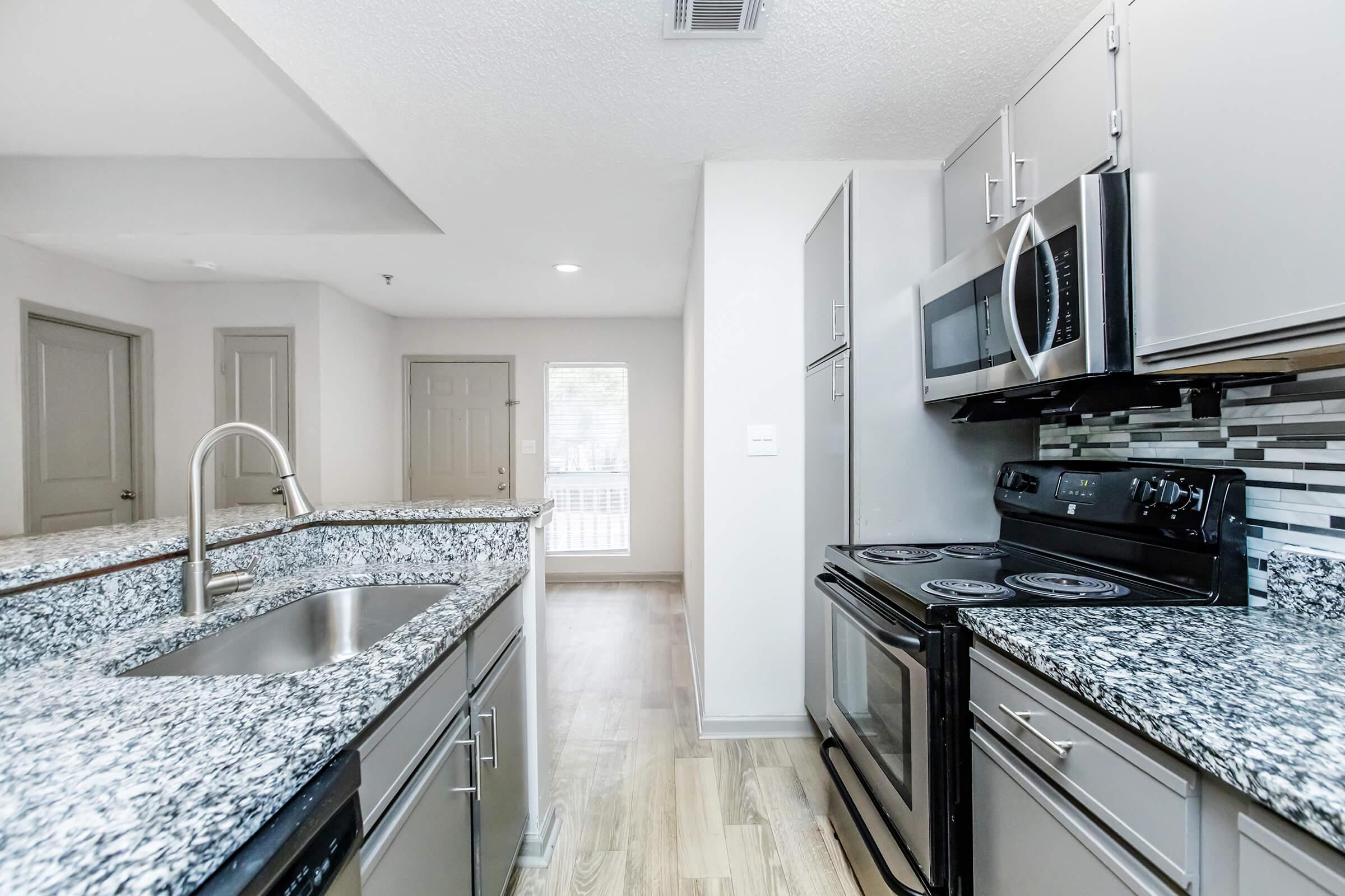 a large kitchen with stainless steel appliances