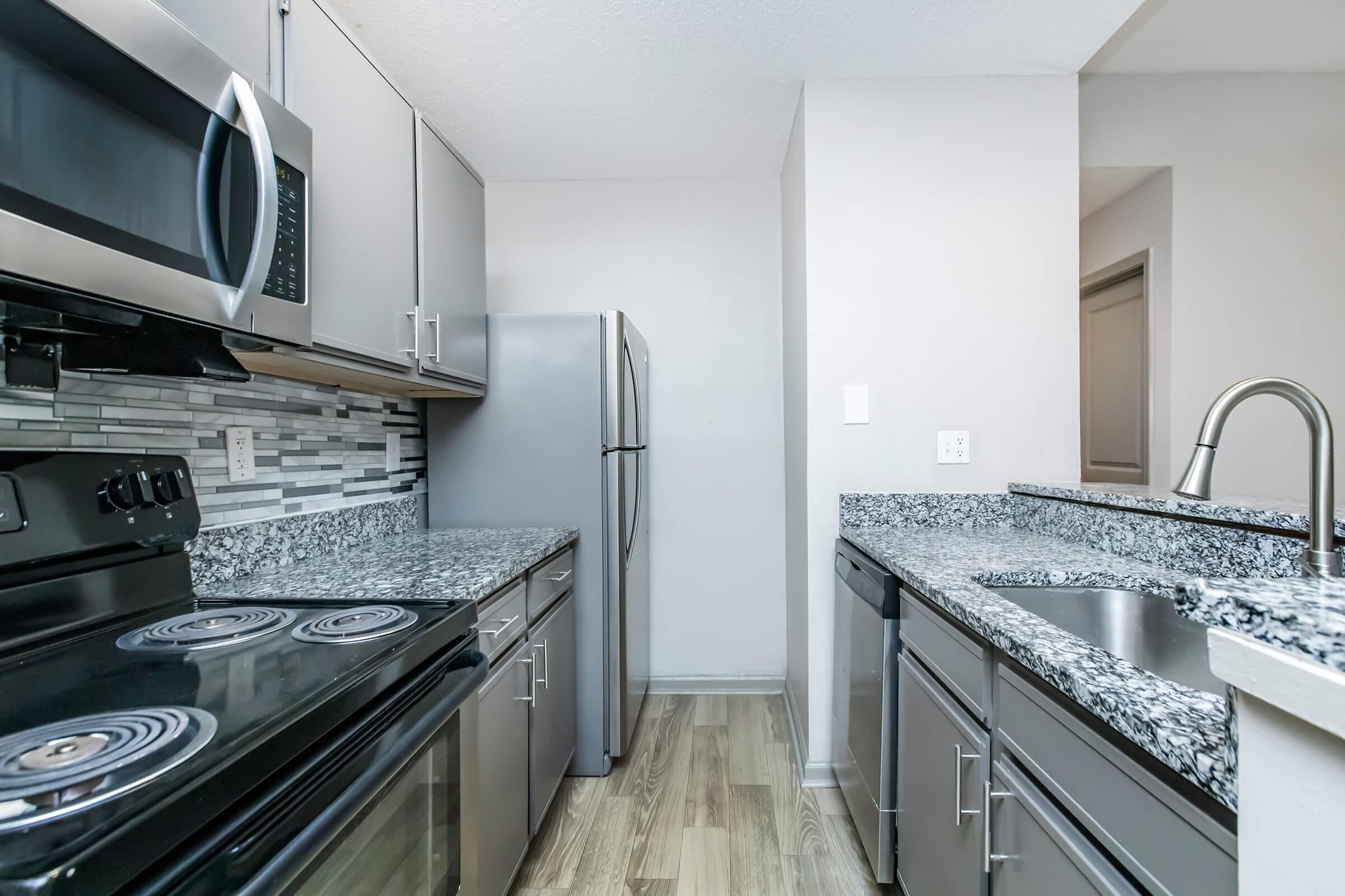 a kitchen with a stove and a sink