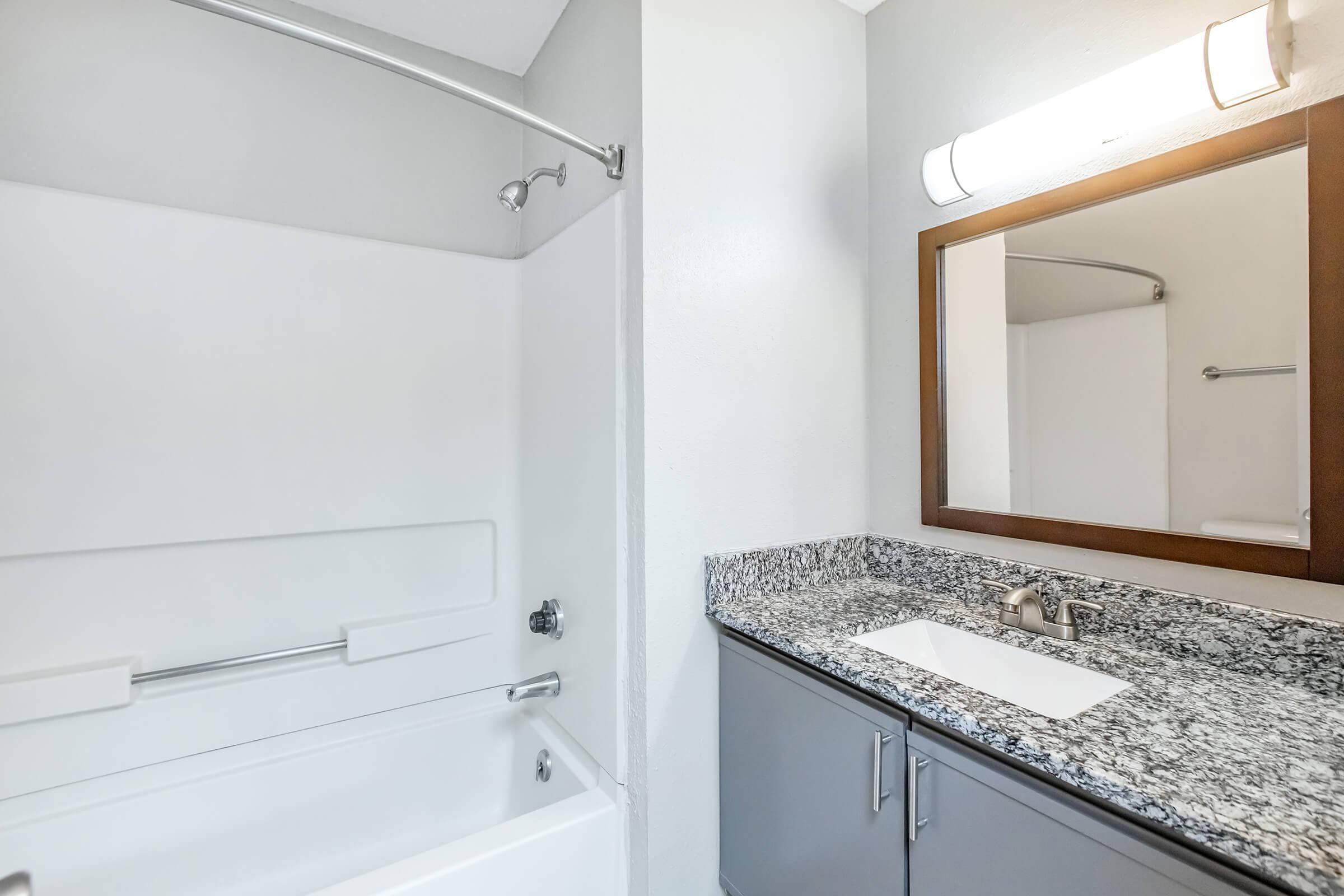 a kitchen with a sink and a mirror