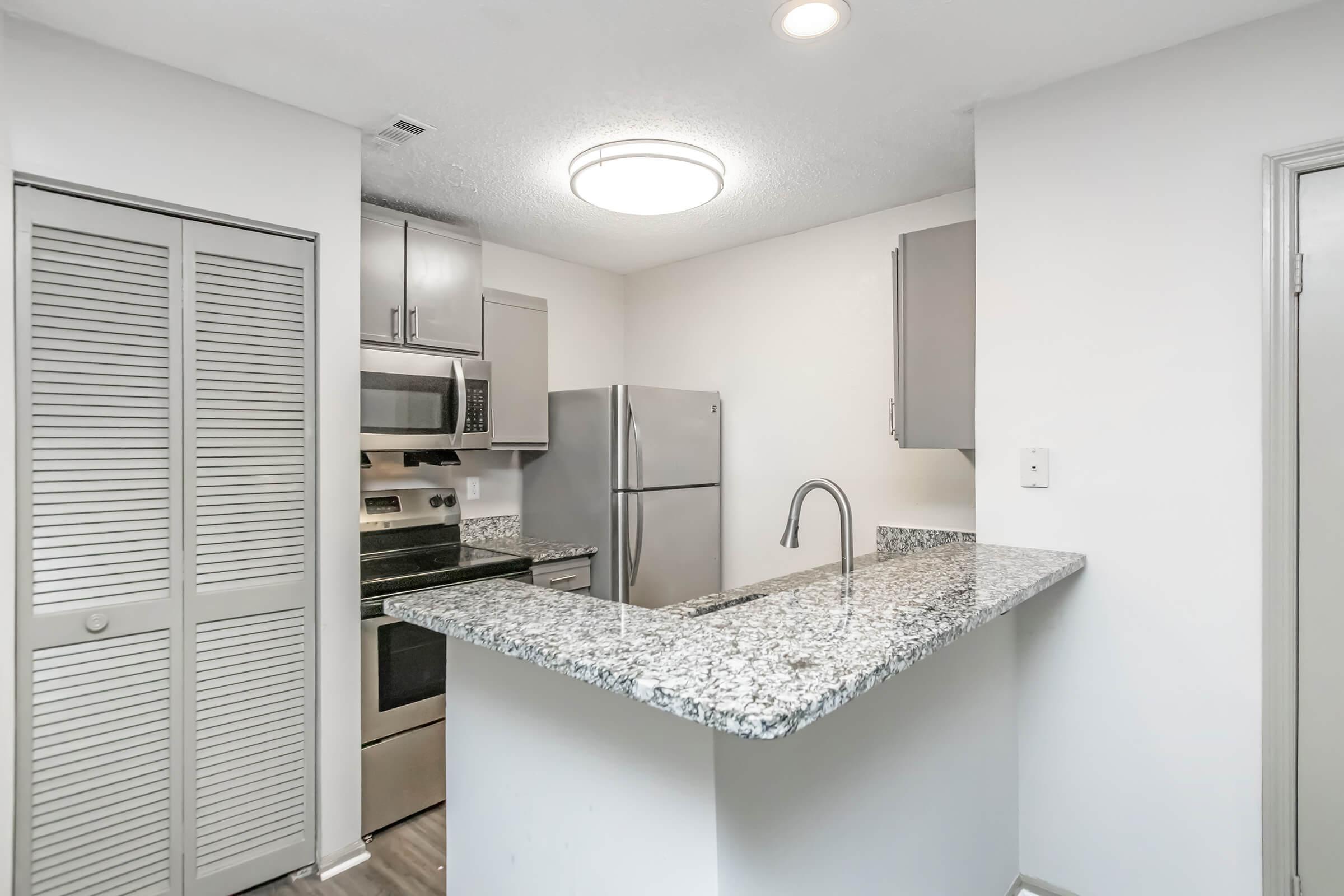 a kitchen with a sink and a mirror