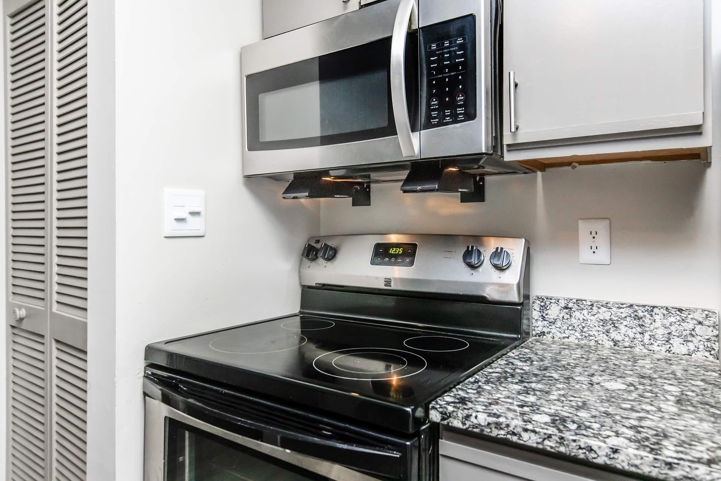 a stove top oven sitting inside of a kitchen