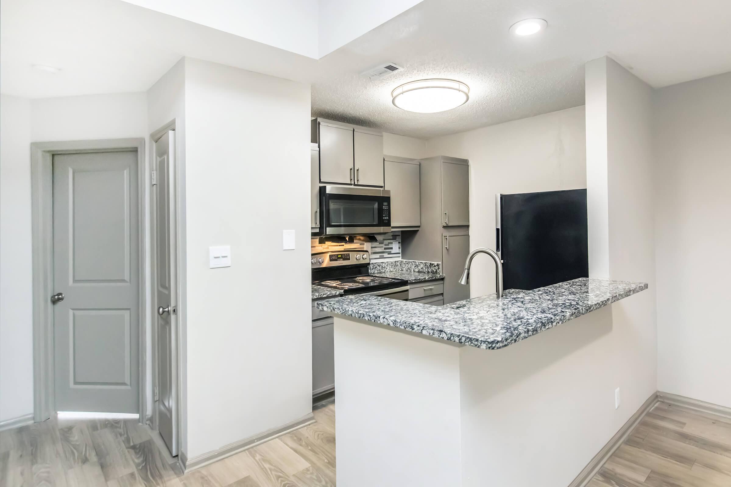 a kitchen with a sink and a refrigerator