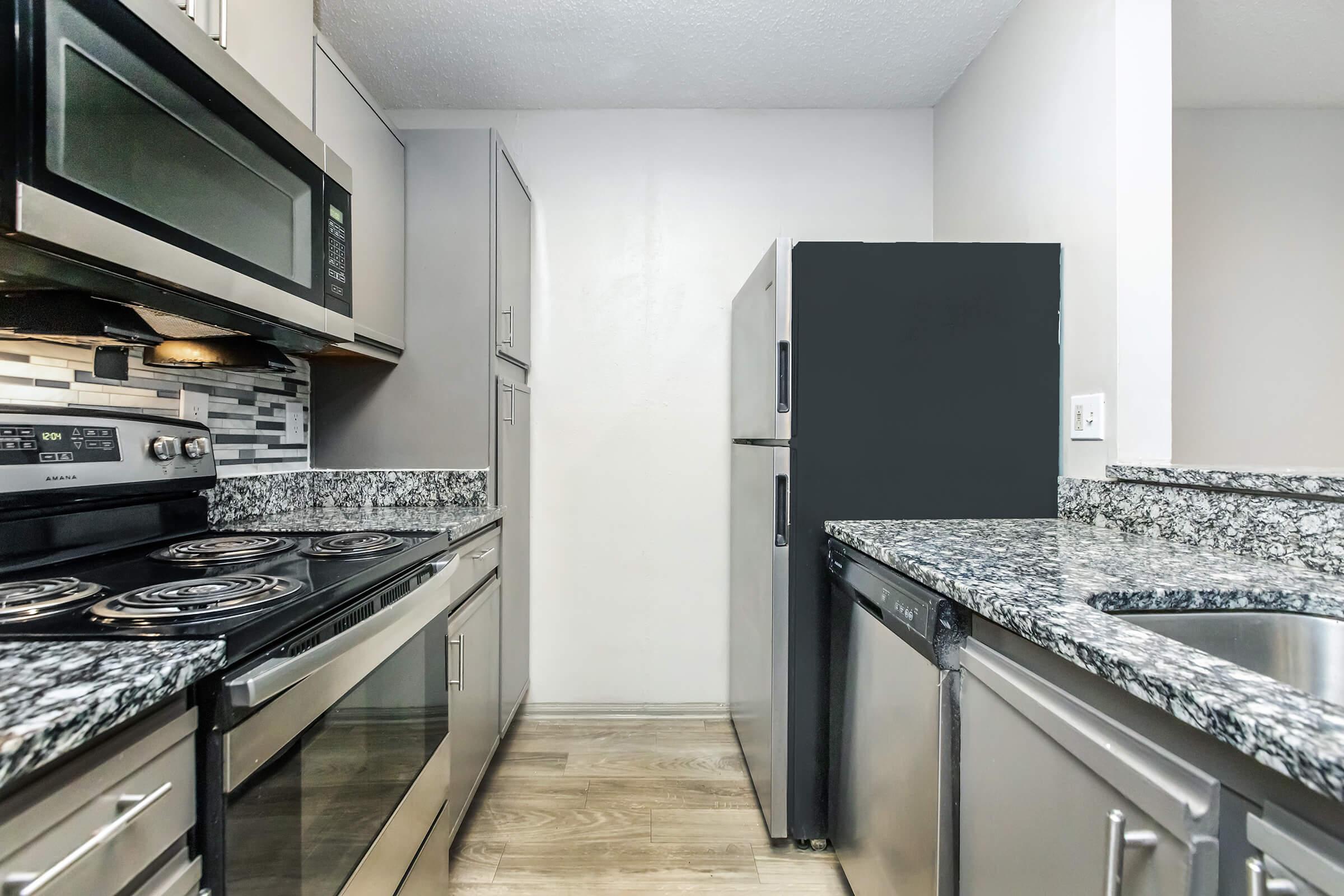 a large kitchen with stainless steel appliances