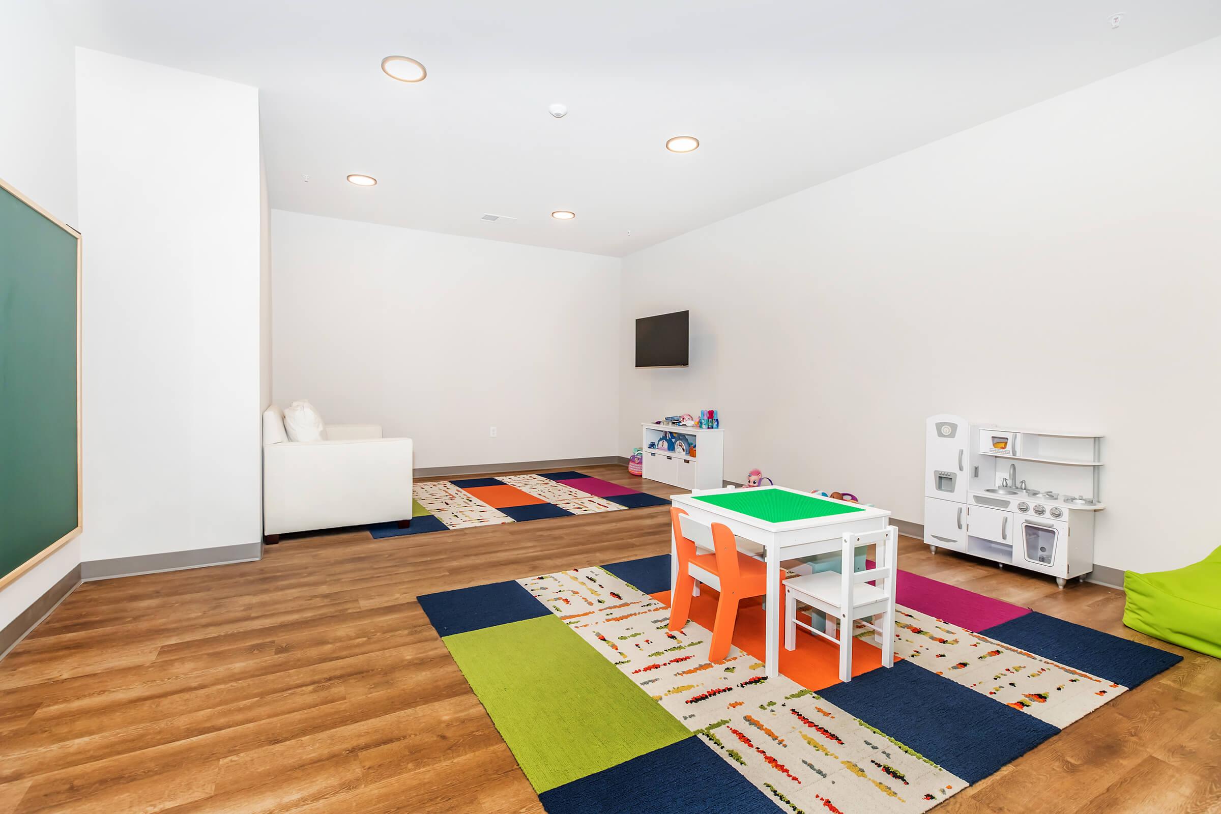 a bedroom with a bed and desk in a room