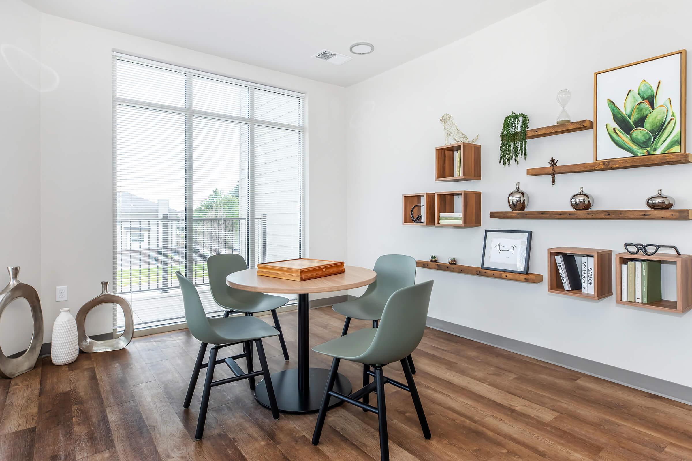 a living room filled with furniture and a large window