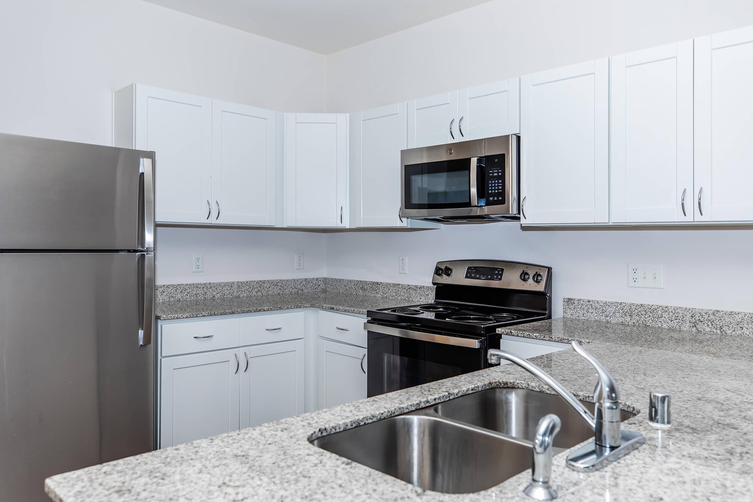 a kitchen with stainless steel appliances and wooden cabinets