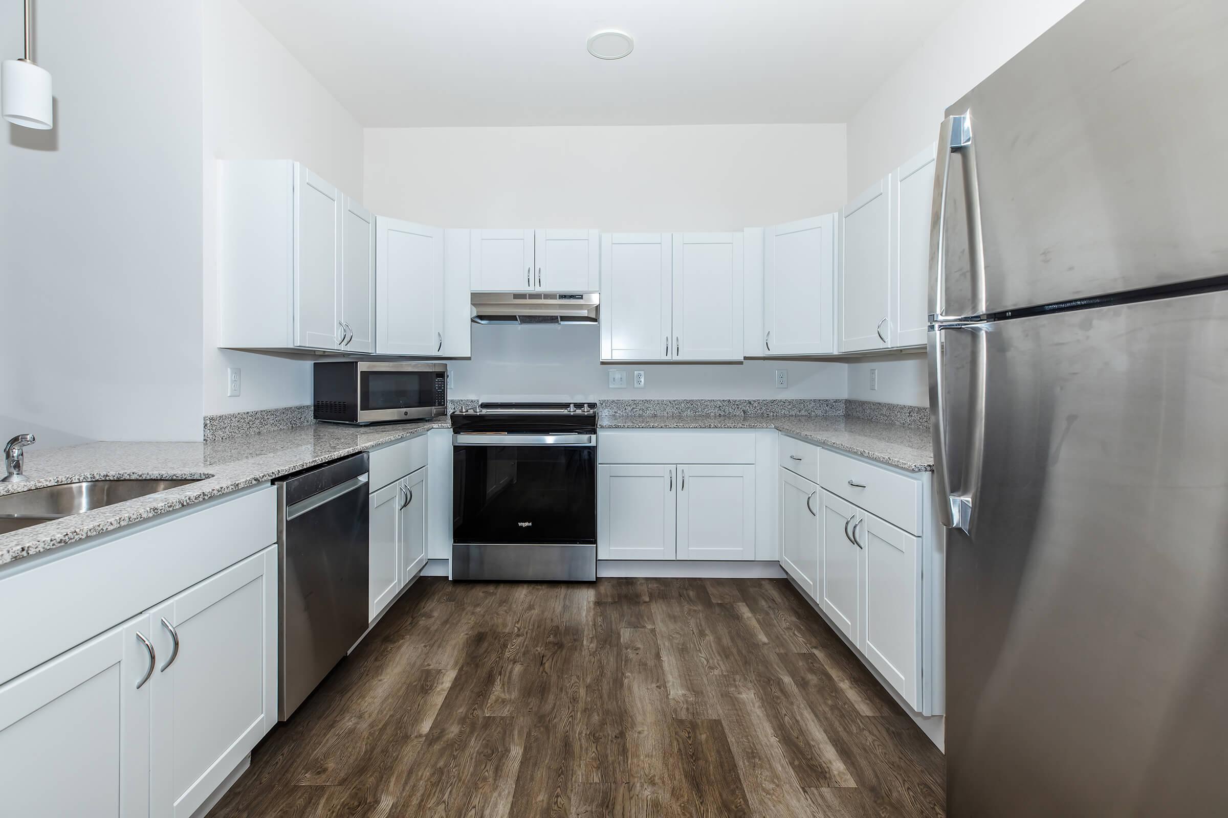 a large kitchen with stainless steel appliances