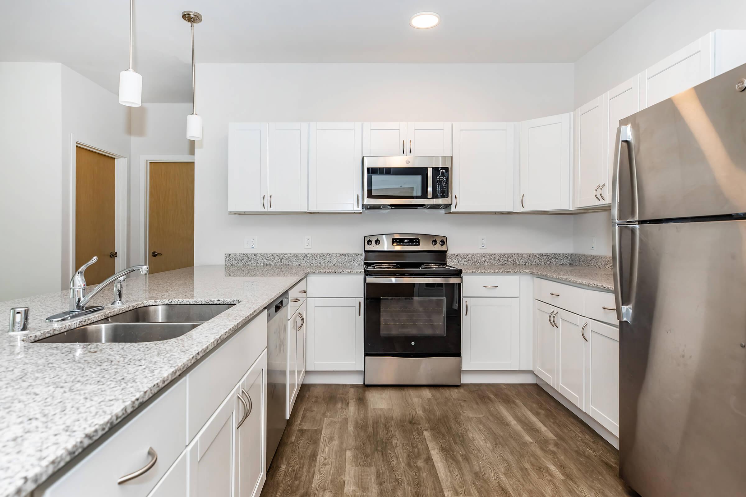 a large kitchen with stainless steel appliances