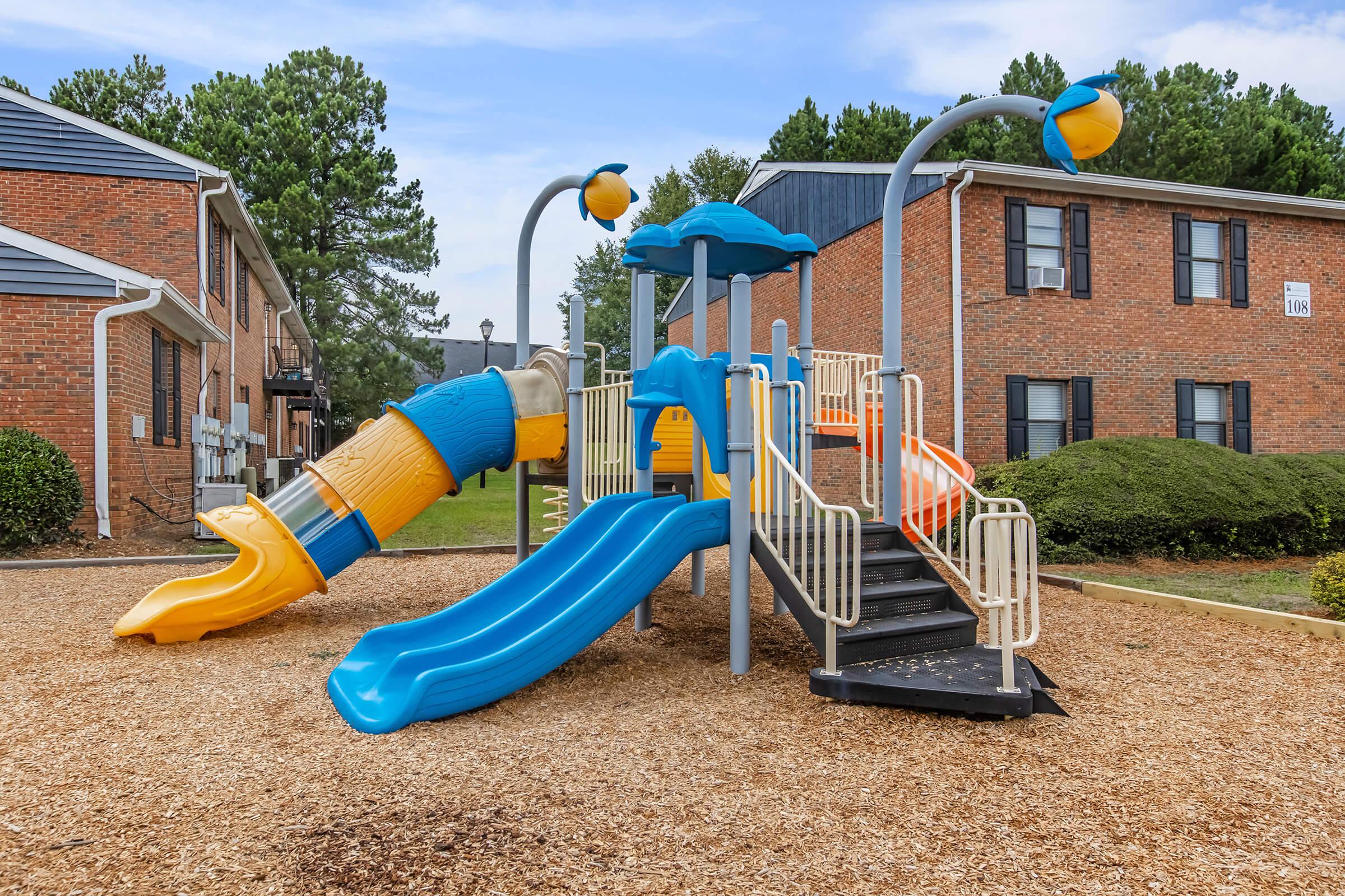 a group of lawn chairs sitting on top of a playground