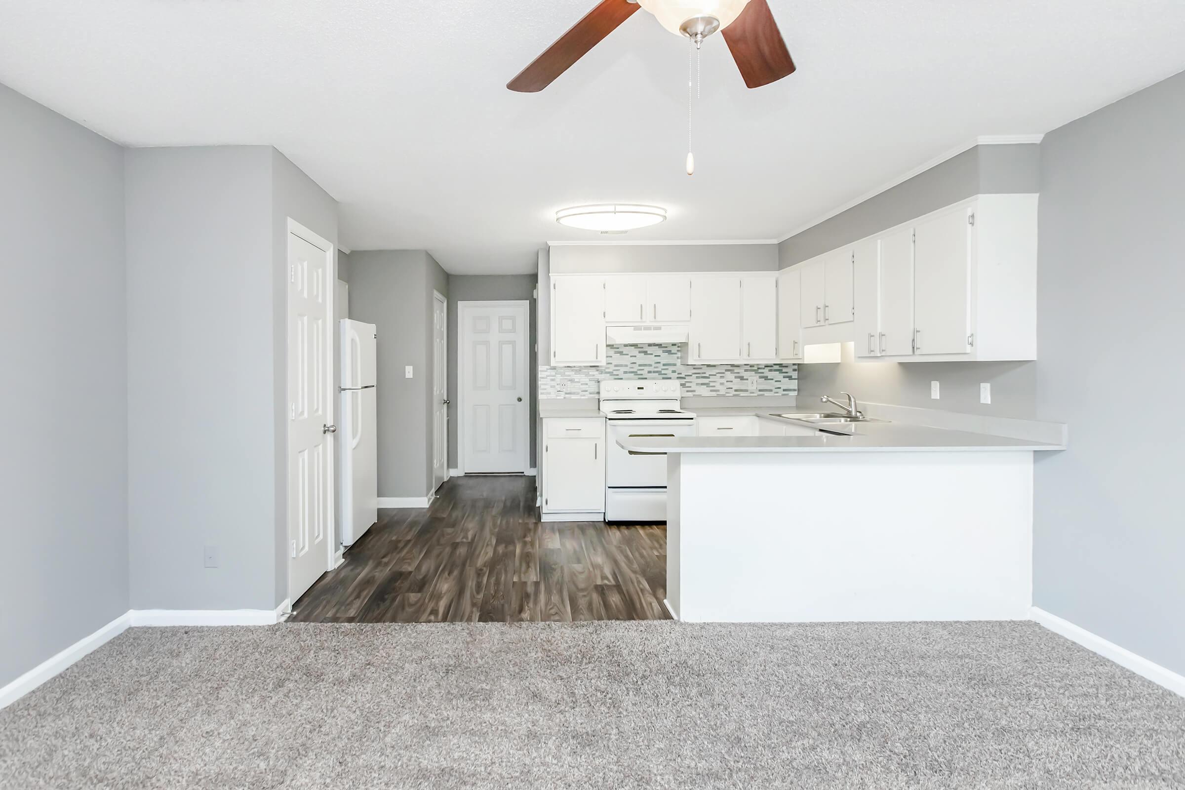 a kitchen area with a building in the background