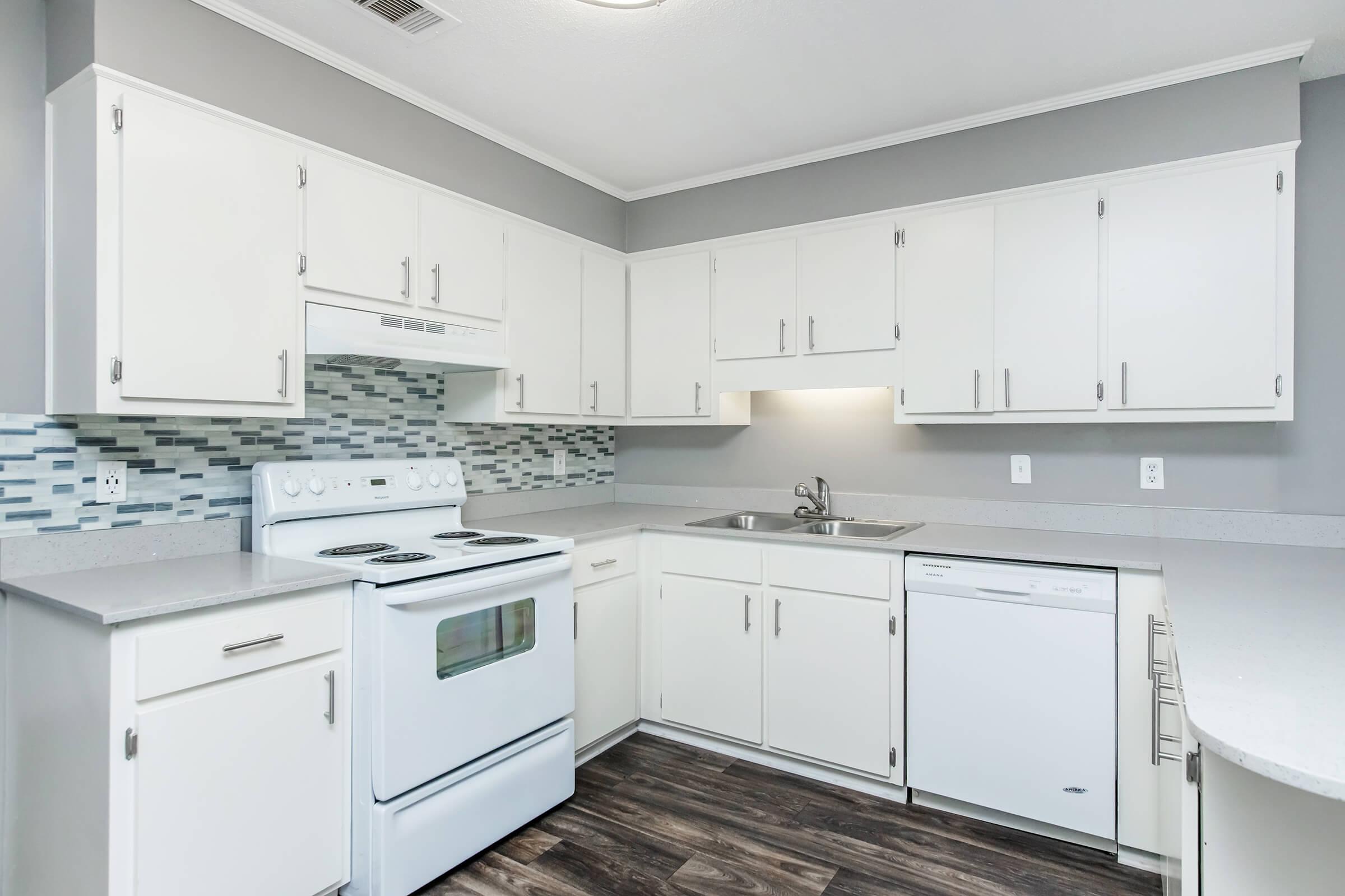 a stove top oven sitting inside of a kitchen