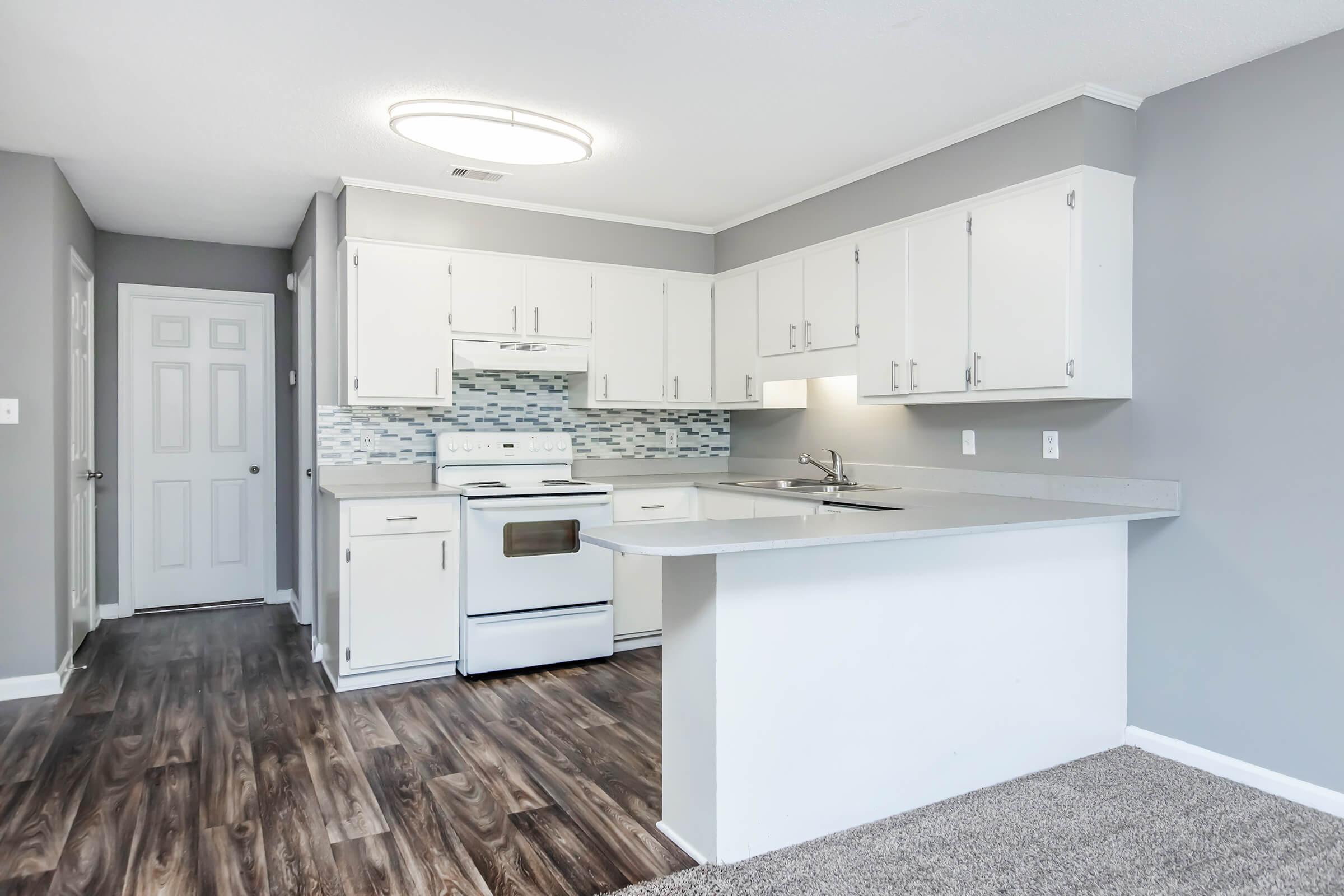 a kitchen with a stove and a refrigerator