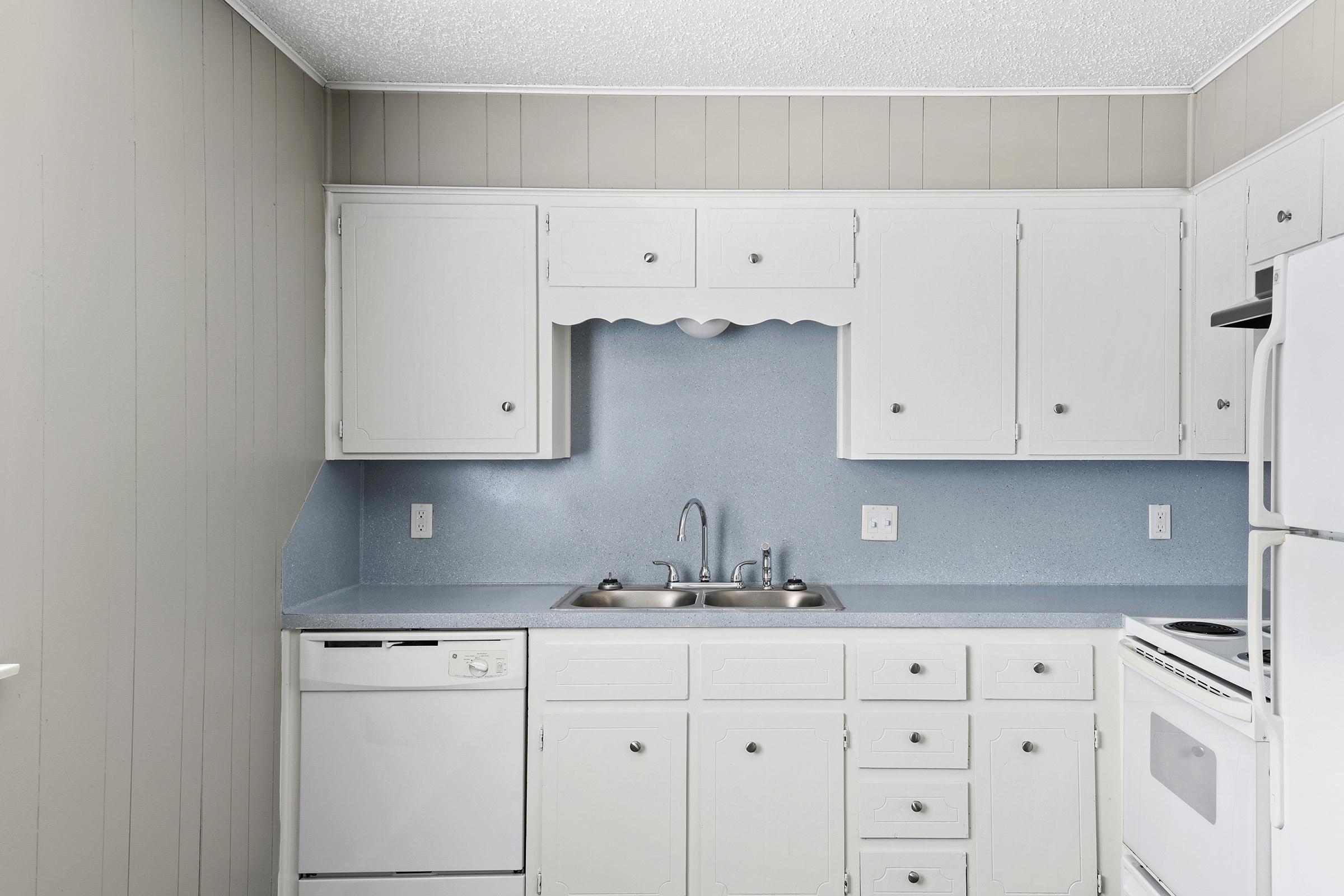 a stove top oven sitting inside of a kitchen