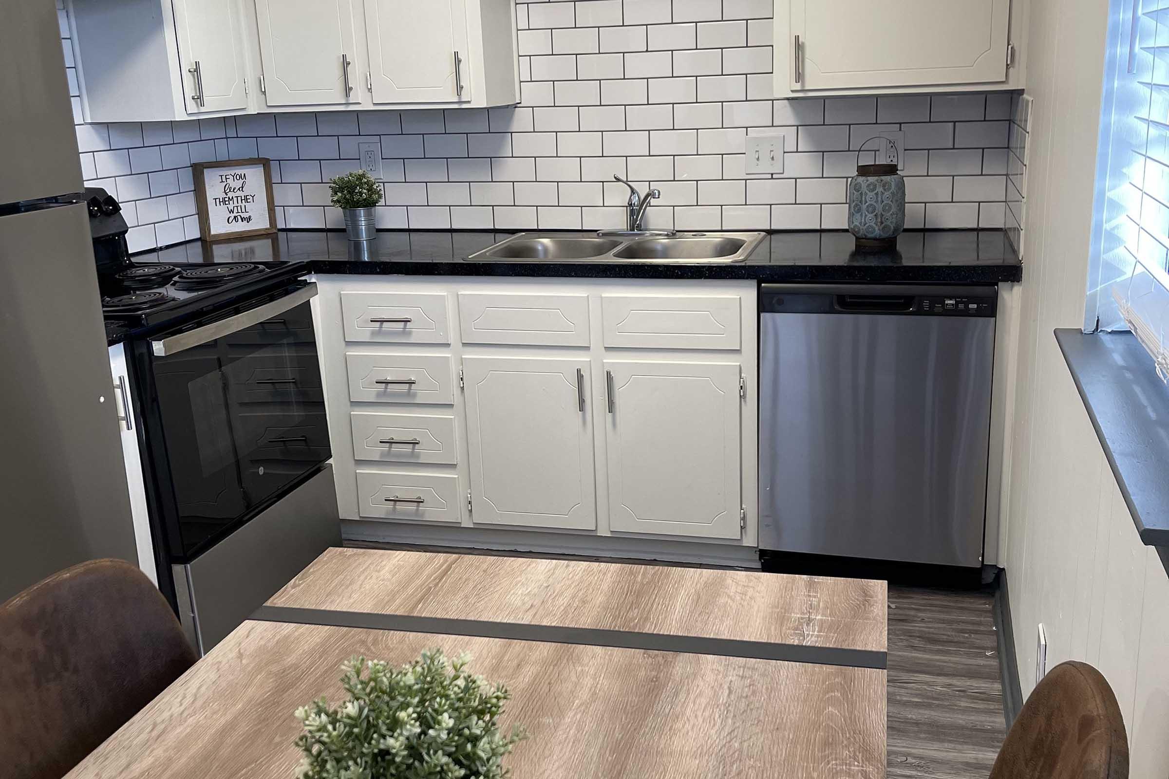 a kitchen with a sink and a window