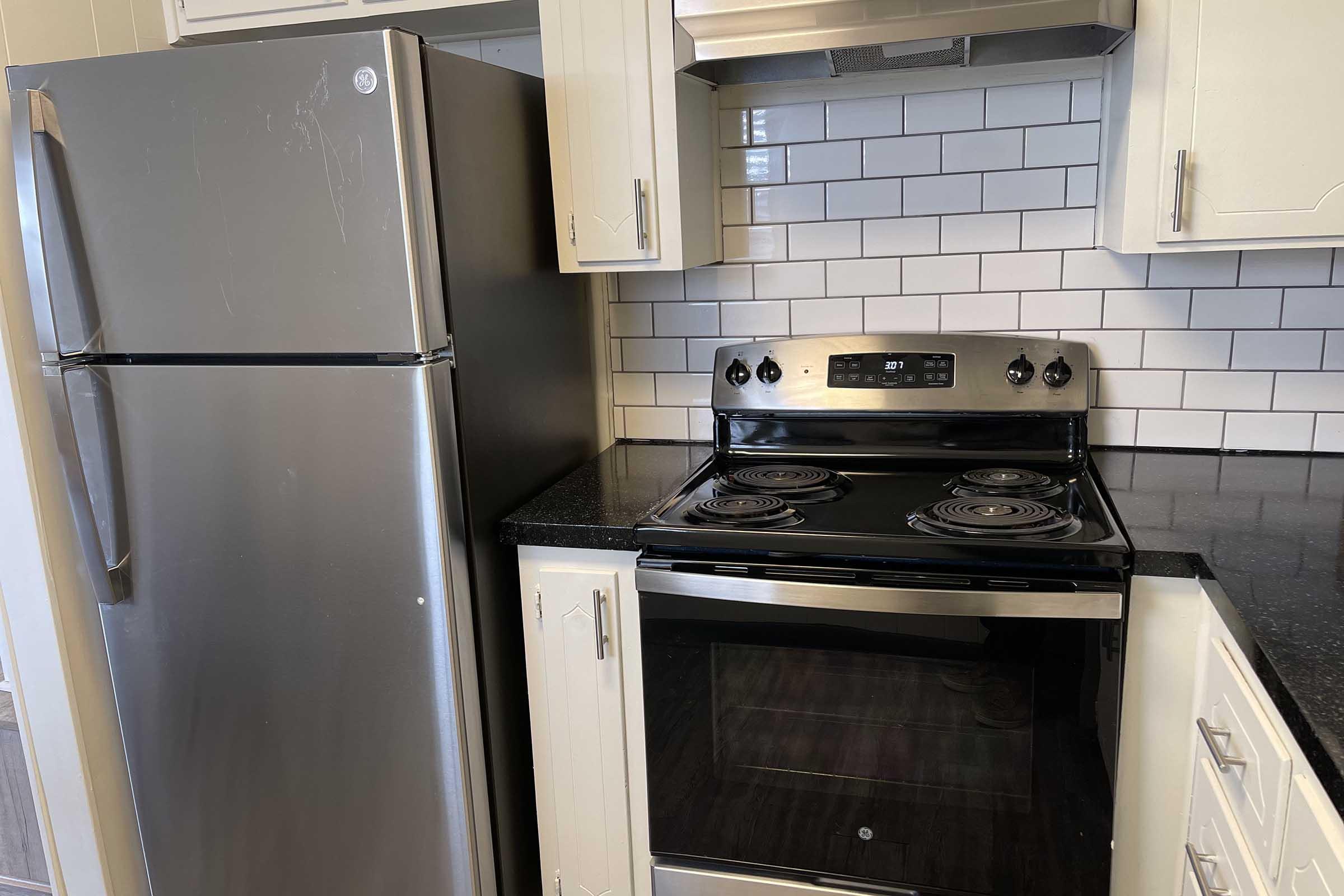 a stove top oven sitting inside of a kitchen