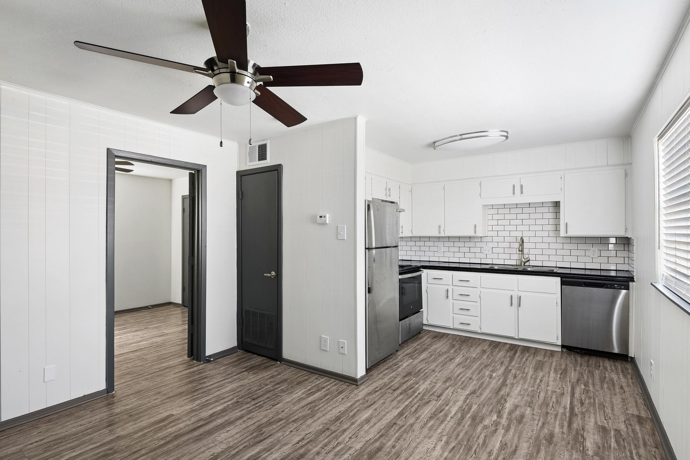 a kitchen with a sink and a mirror