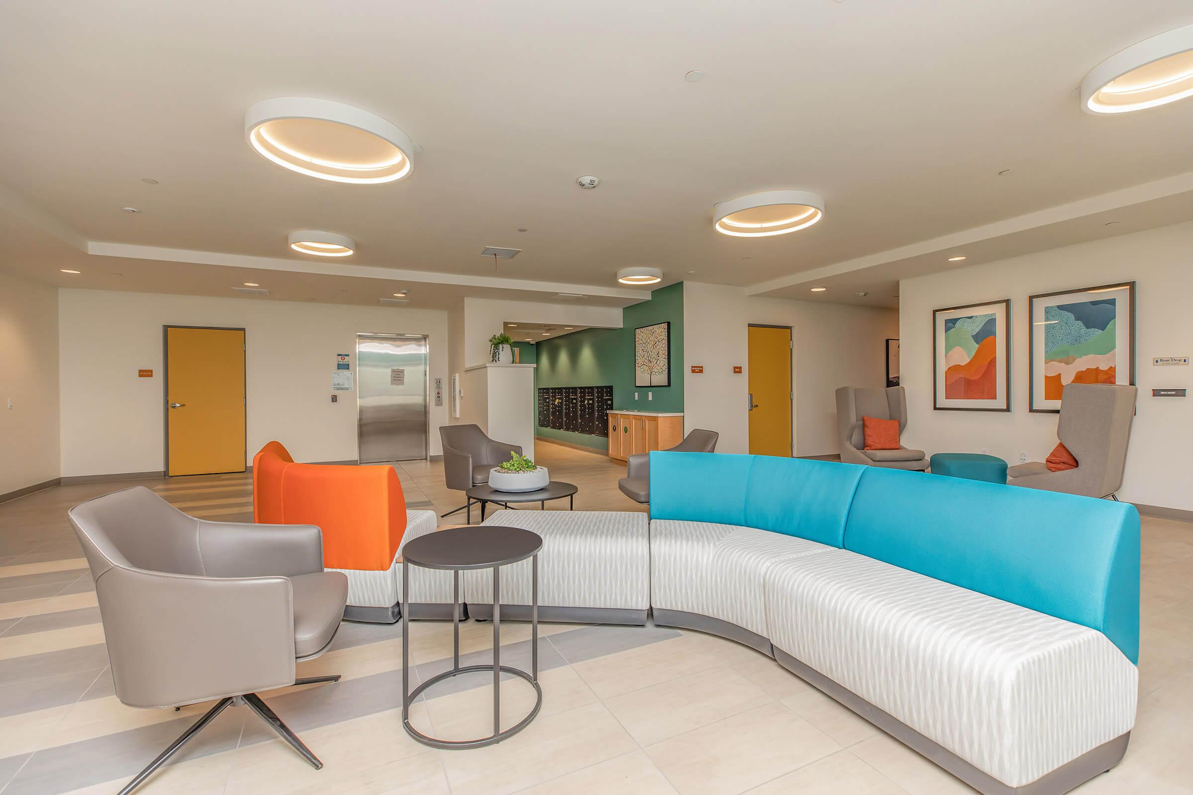 a living room filled with furniture and a blue chair