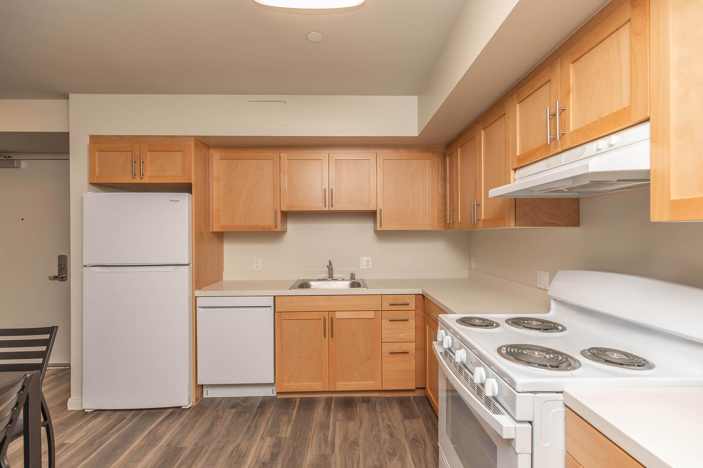 a kitchen with a stove and a refrigerator