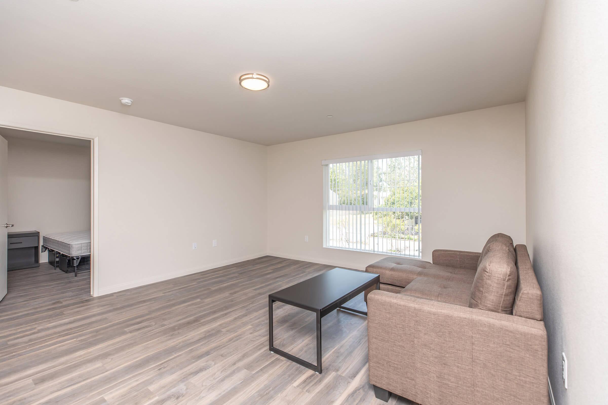 a living room filled with furniture and a large window