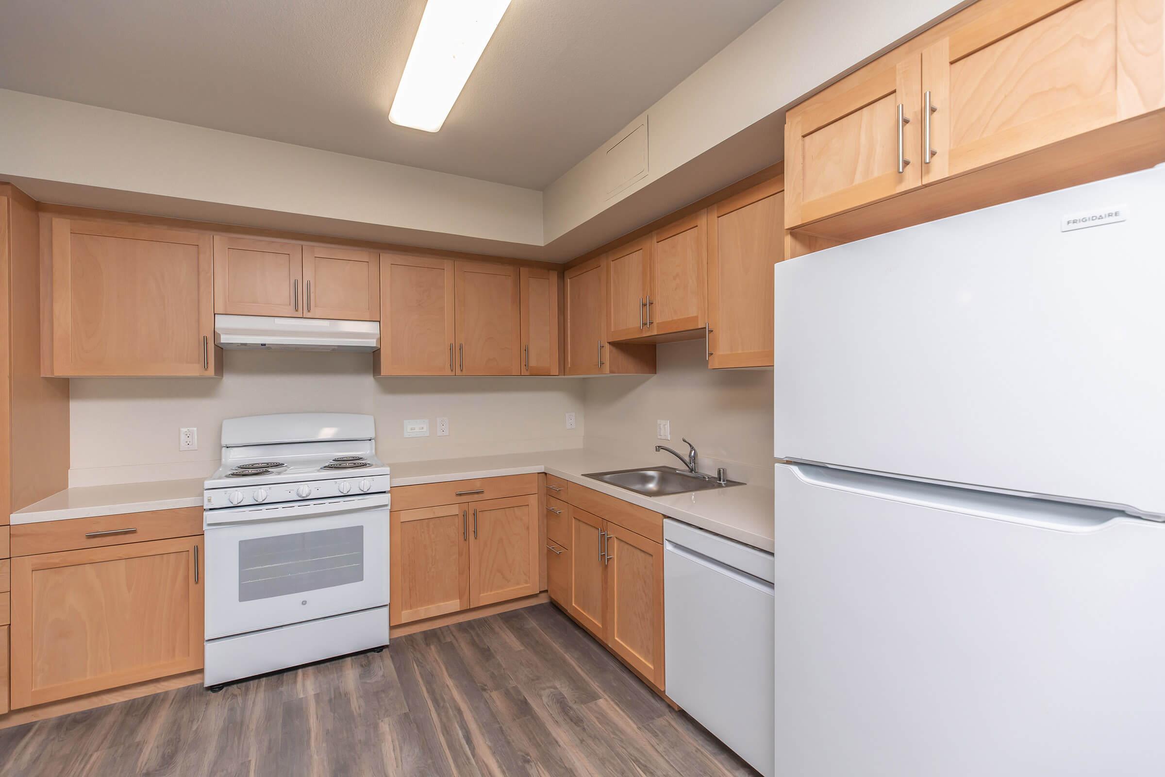 a kitchen with a stove and a refrigerator