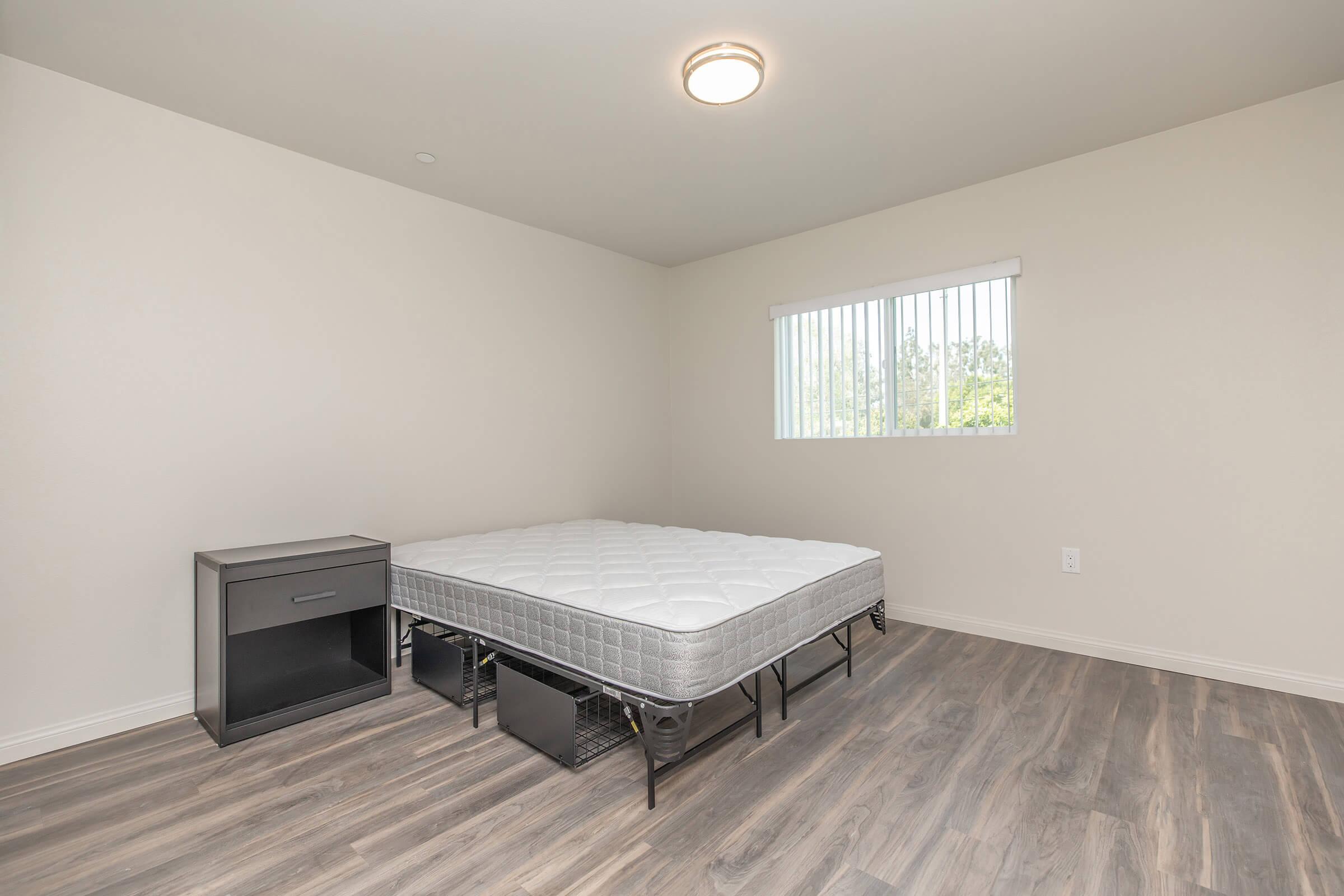 a bedroom with a bed and desk in a room