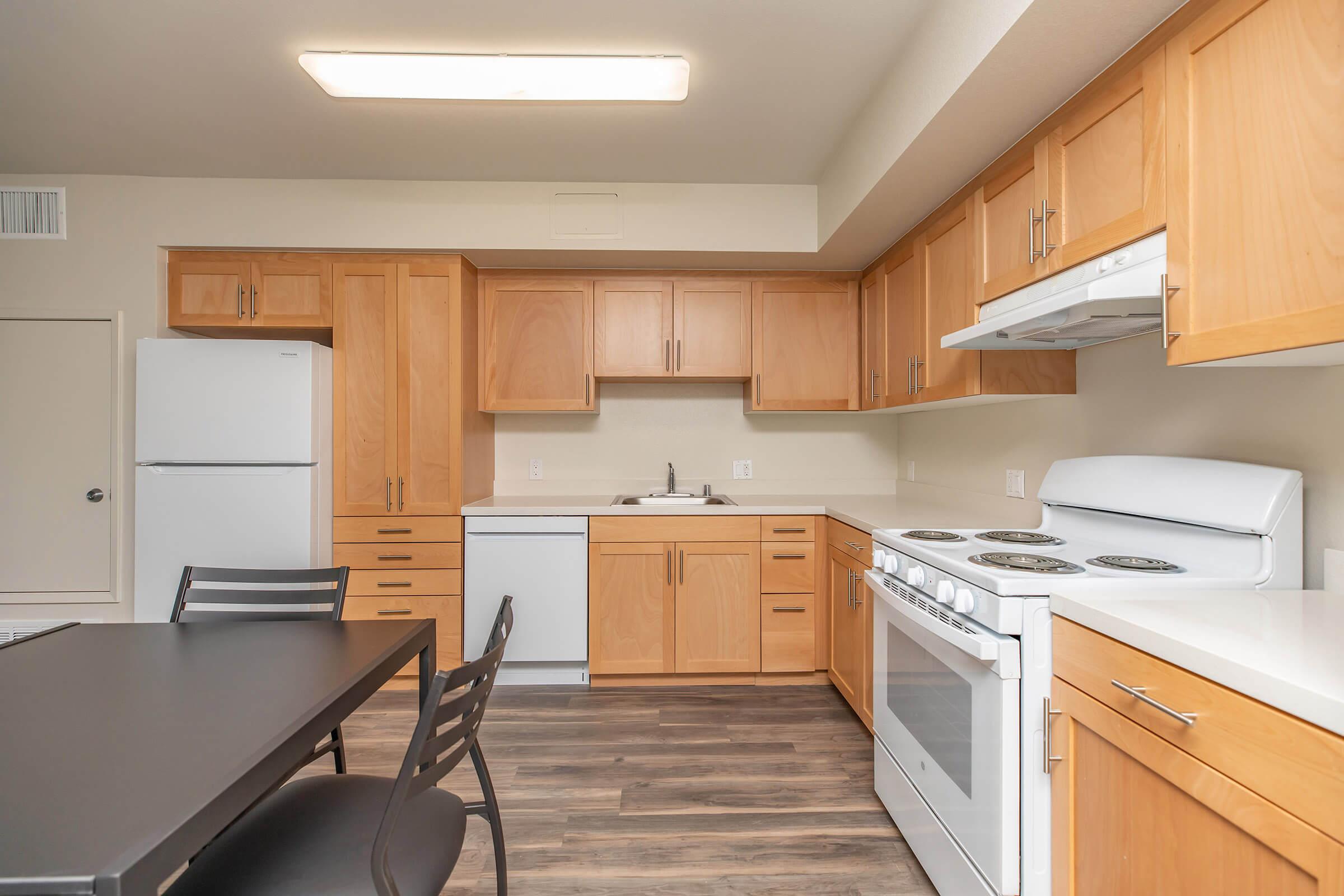 a kitchen with a stove and a refrigerator