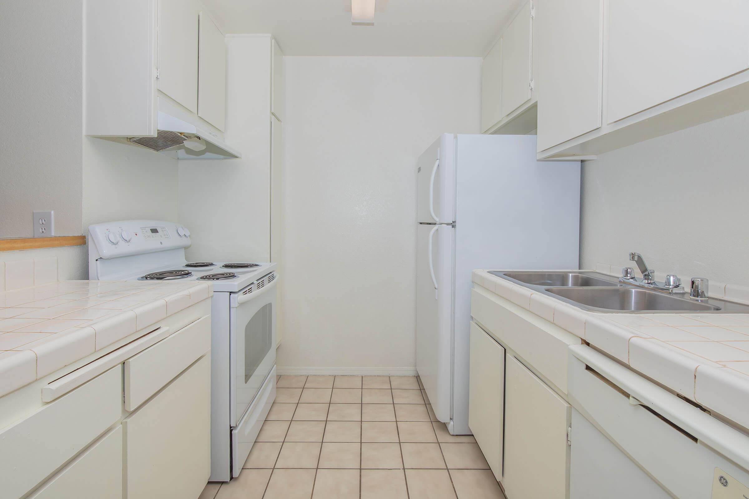 a kitchen with a sink and a refrigerator