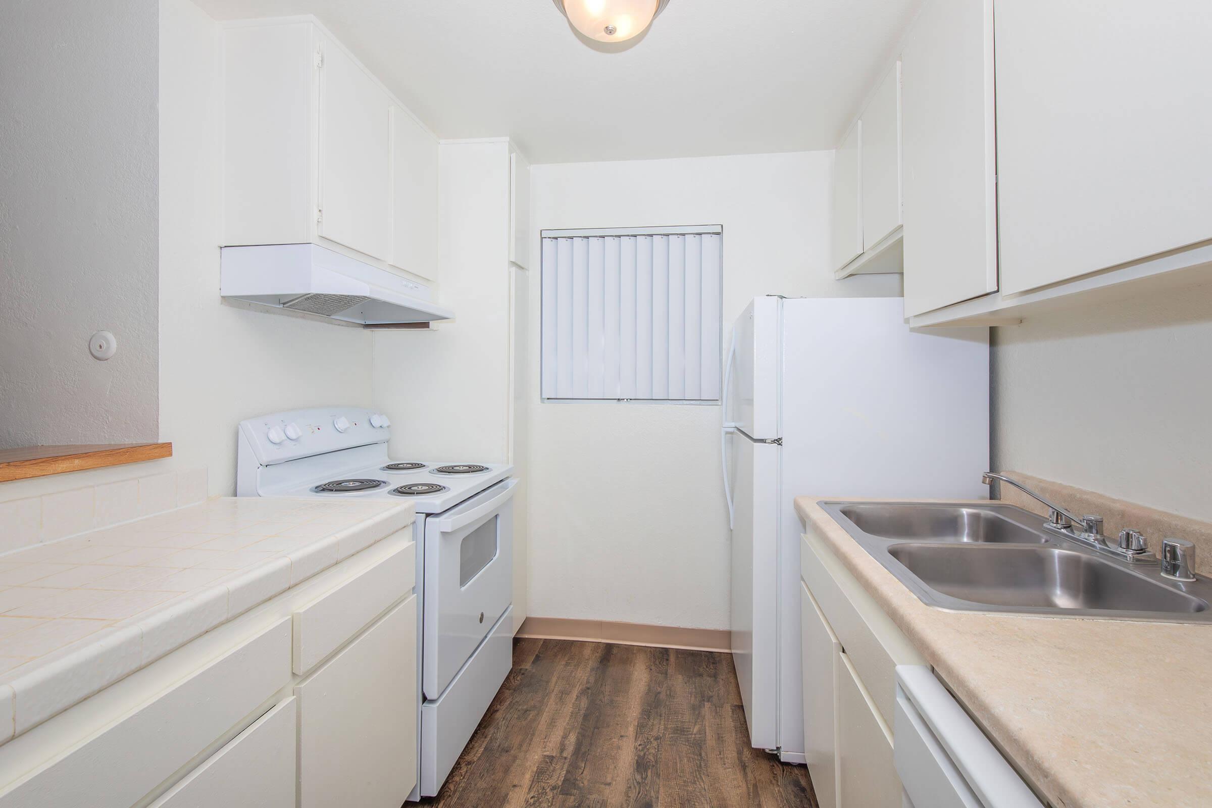 a kitchen with a stove sink and refrigerator