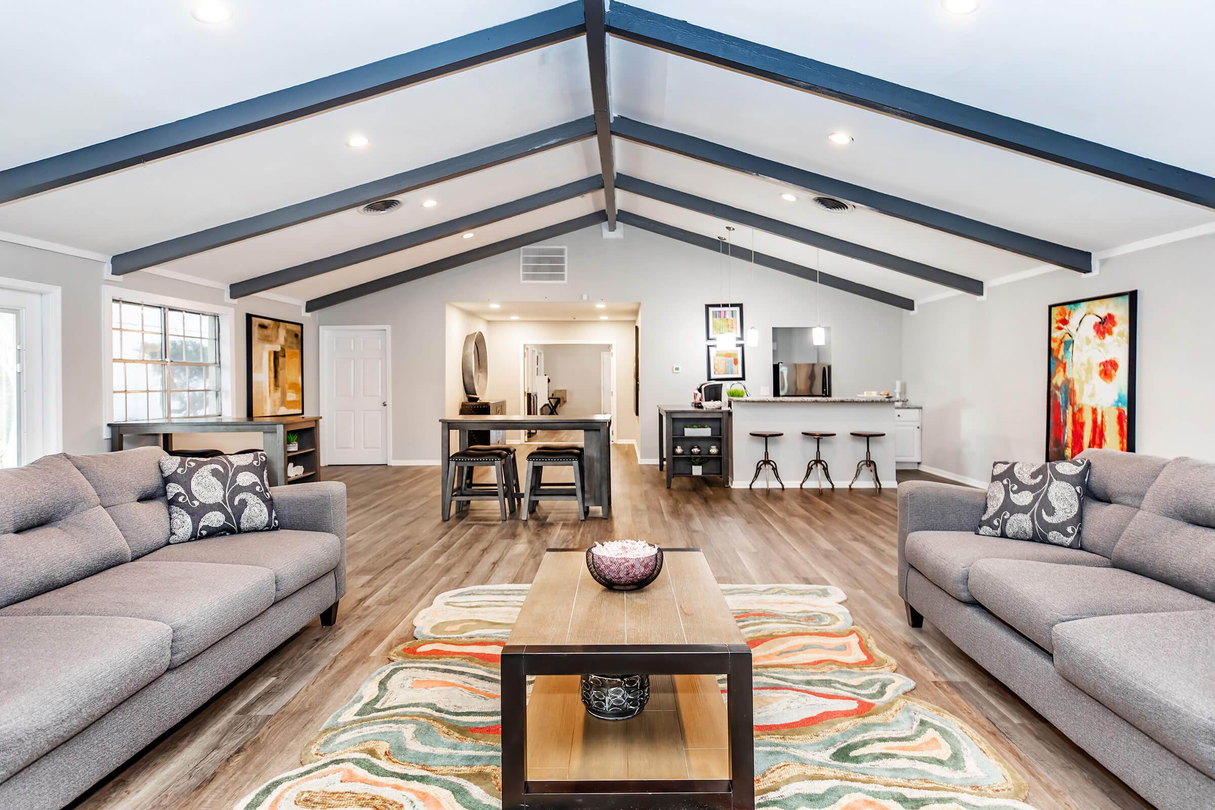 a living room filled with furniture and a flat screen tv