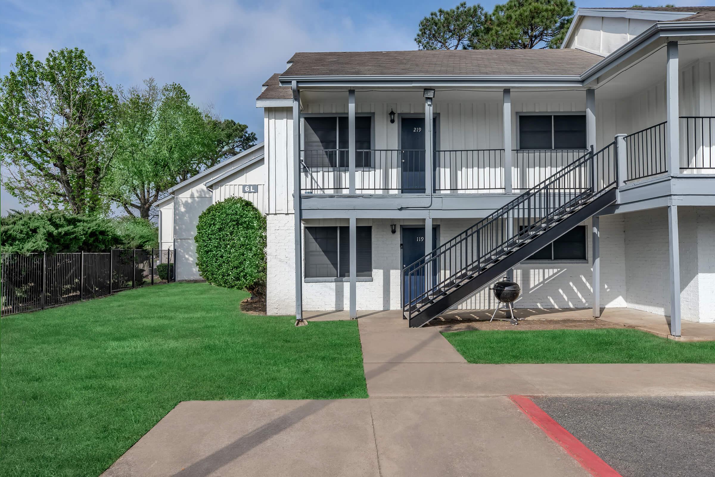 a house with a lawn in front of a building